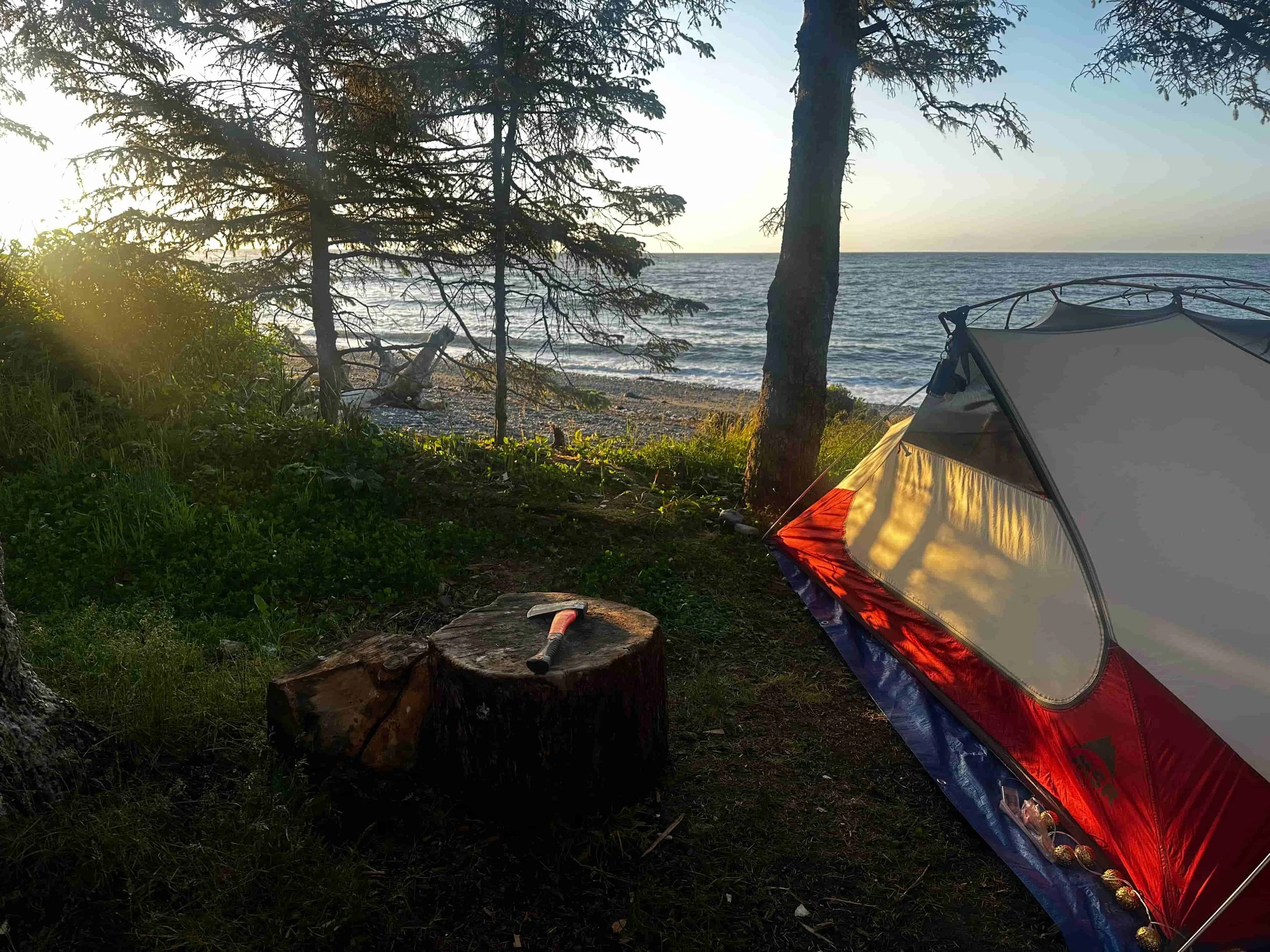 Beach camping at Cluxewe Resorte with tent at sunset on Vancouver Island coastline near Port Hardy