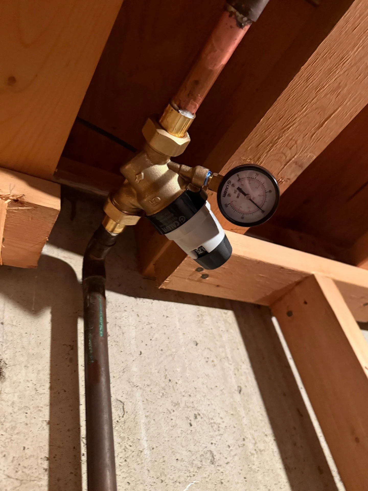 Installed a pressure reducing valve on this copper line and set it with the gauge for consistent pressure. Clean solder joints and proper support at the joist keep the run solid. Everyday plumbing, done carefully.

Please call/text 801-808-1236 to ma