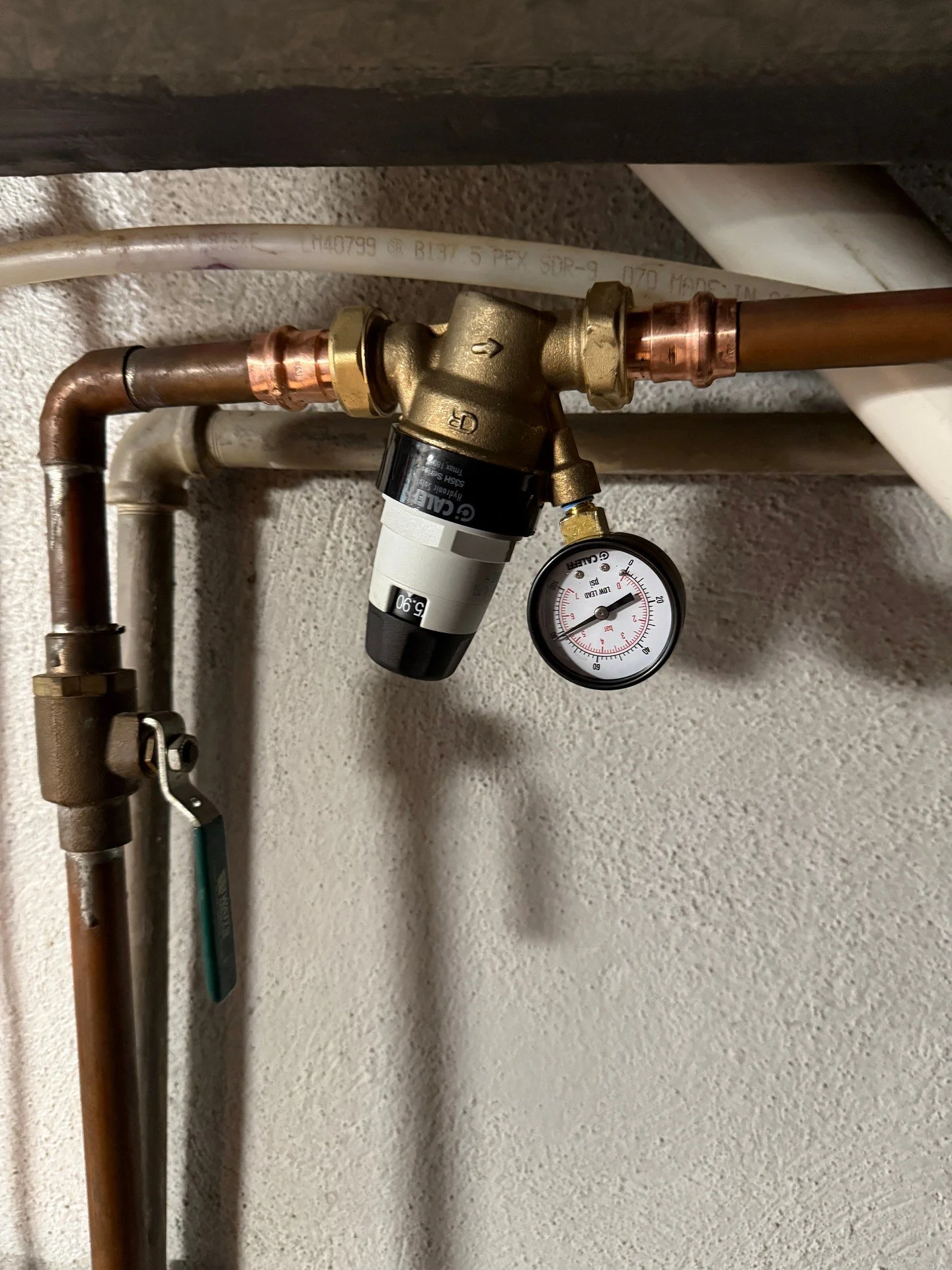 Pressure reducing valve installed on the copper main today, with a gauge to monitor line pressure. Copper fittings tied in clean on both sides and a ball valve below for a straightforward shutoff. Kept everything straight, supported, and easy to reac