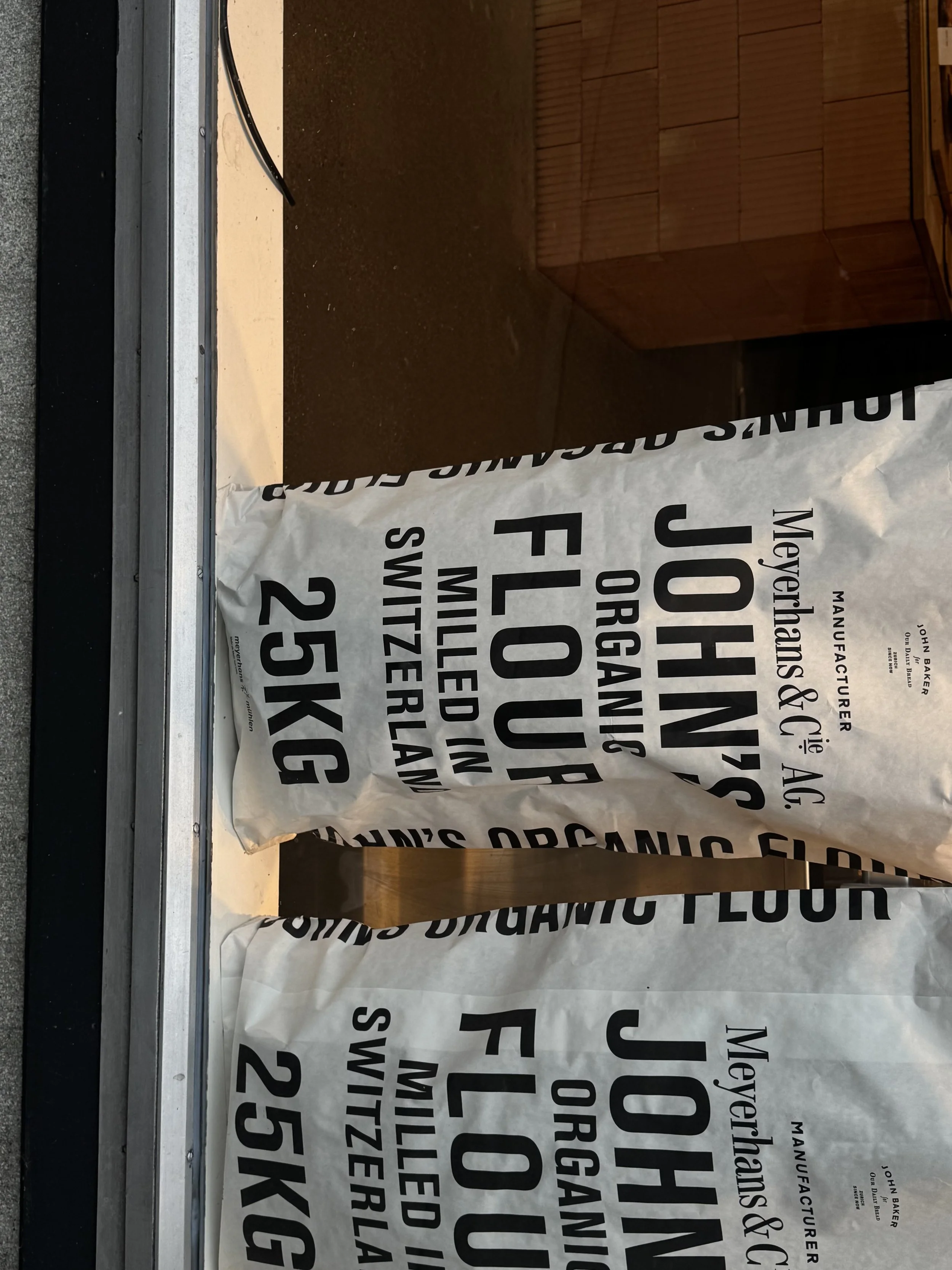 A large bag of organic all-purpose flour from Johnson's Meyershand & Gilbe AG, weighing 25 kg, sitting on a counter or table.