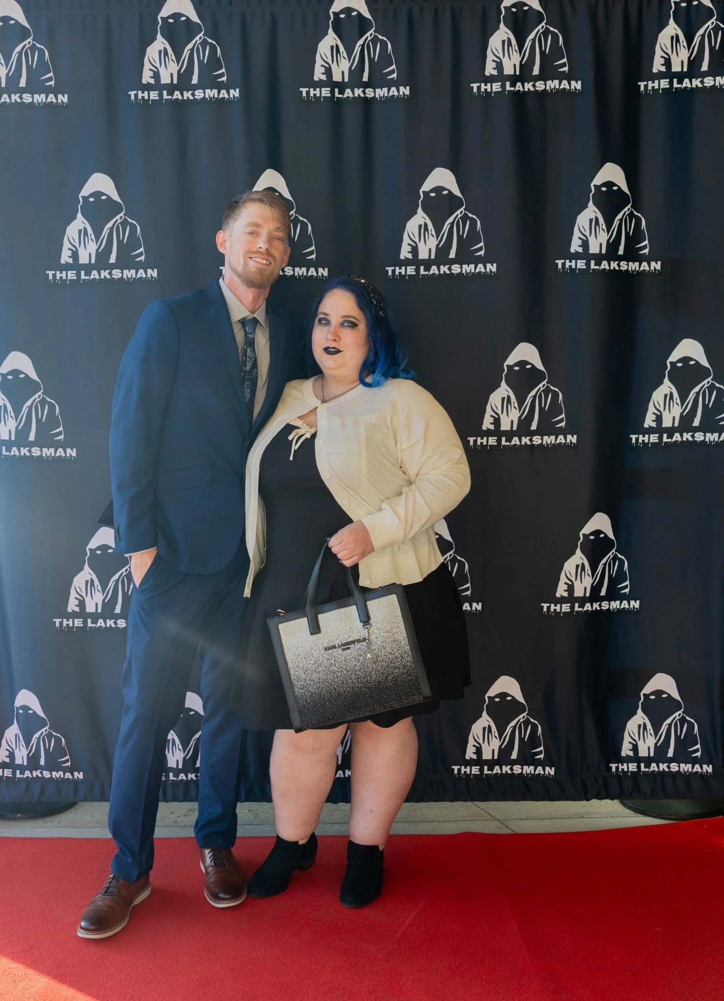 Man and woman on the red carpet at a movie premier.