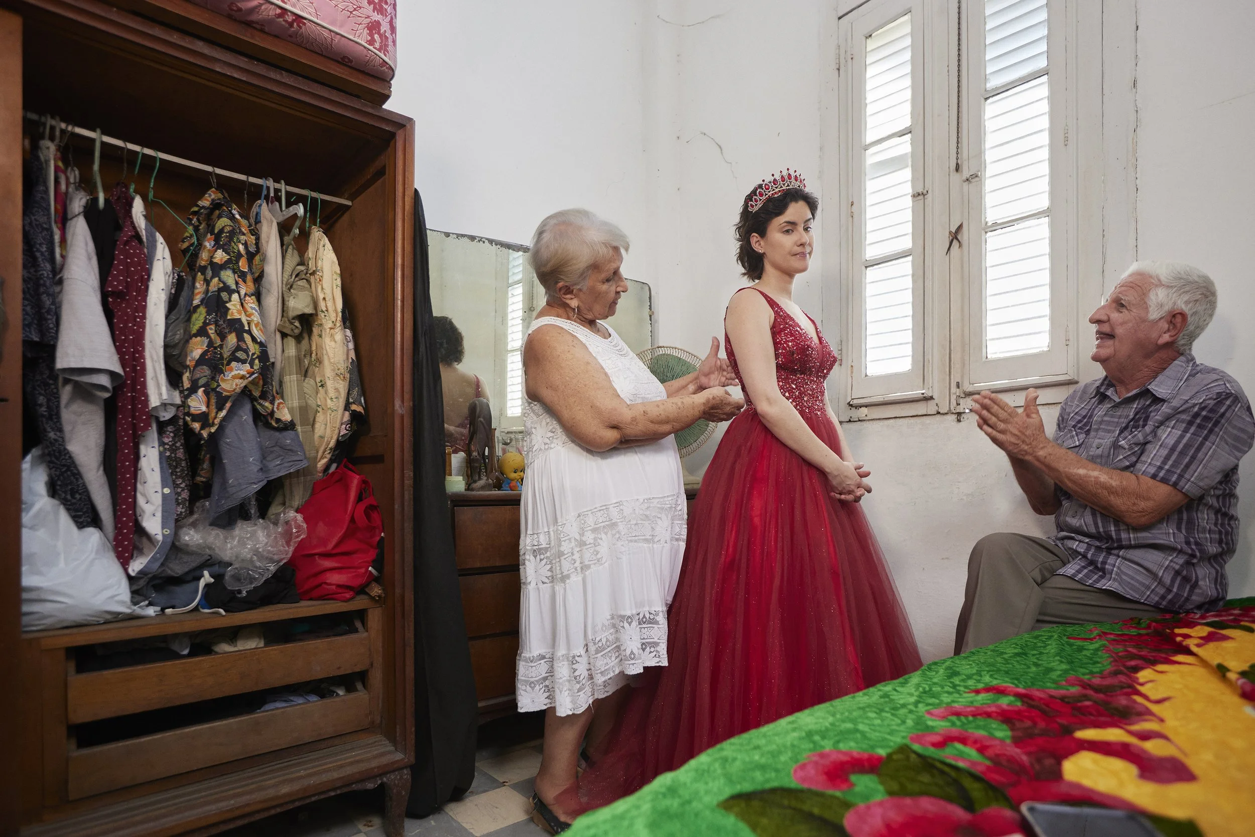 My grandmother Tania D. insists that I take some photos of myself in this 15th
birthday dress, my grandfather José intercedes for me