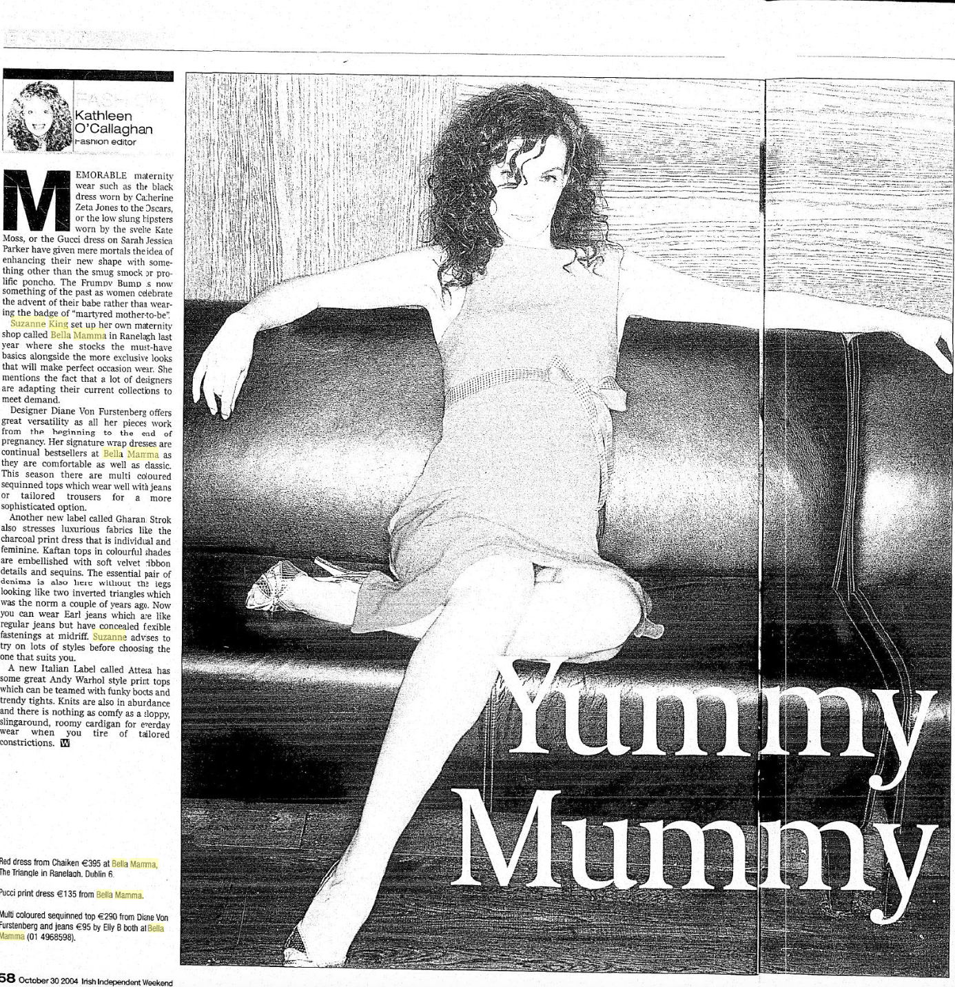 A woman with curly hair sitting on a couch, wearing a dress with a raised leg, surrounded by text and large letters that say "Yummy Mummy."