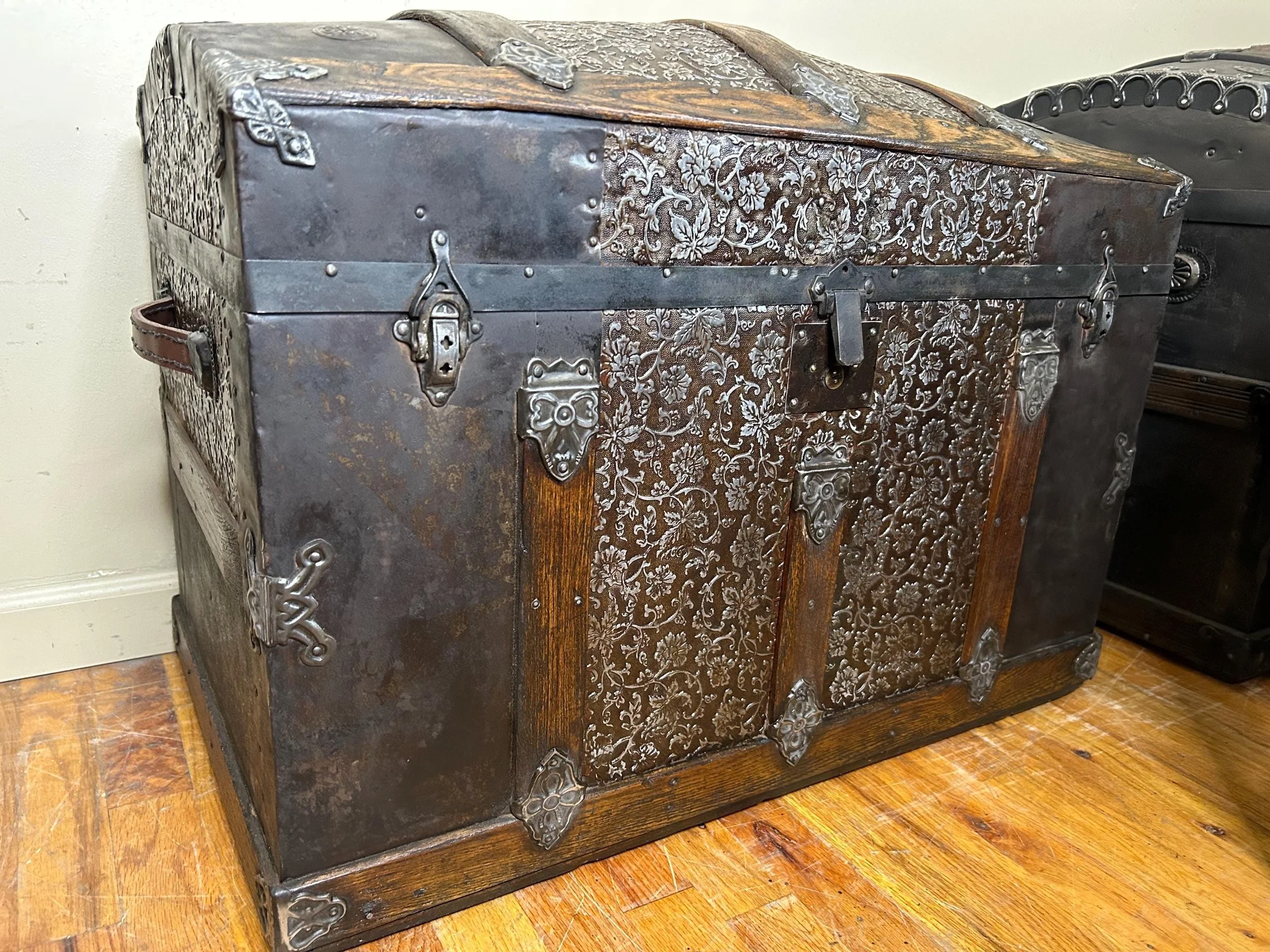 Large Victorian humpback treasure chest professionally refinished in brown and black.