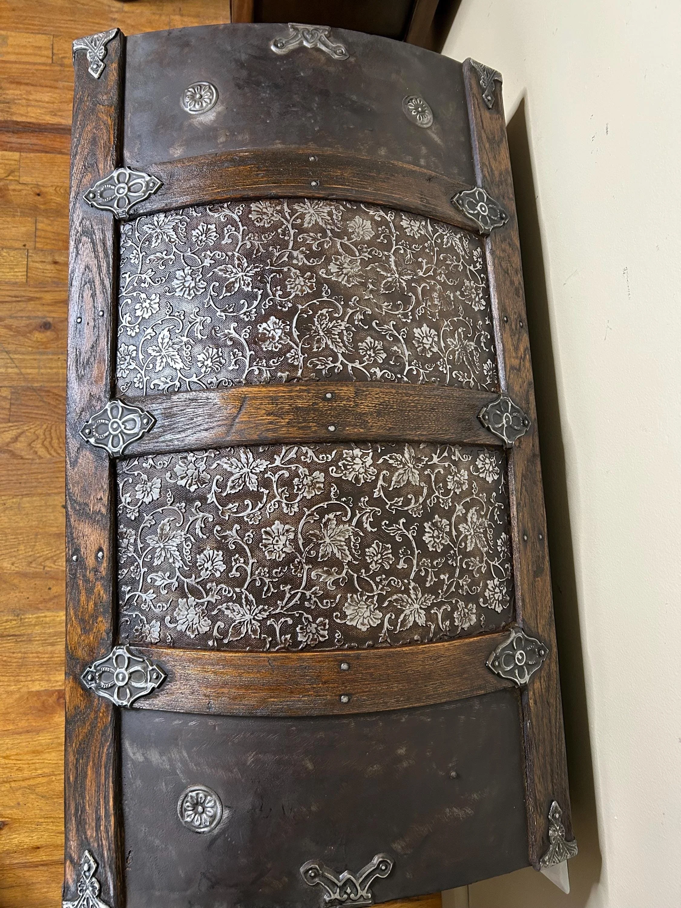 Detailed close-up of hand-buffed bright metal relief and ornate floral patterns.