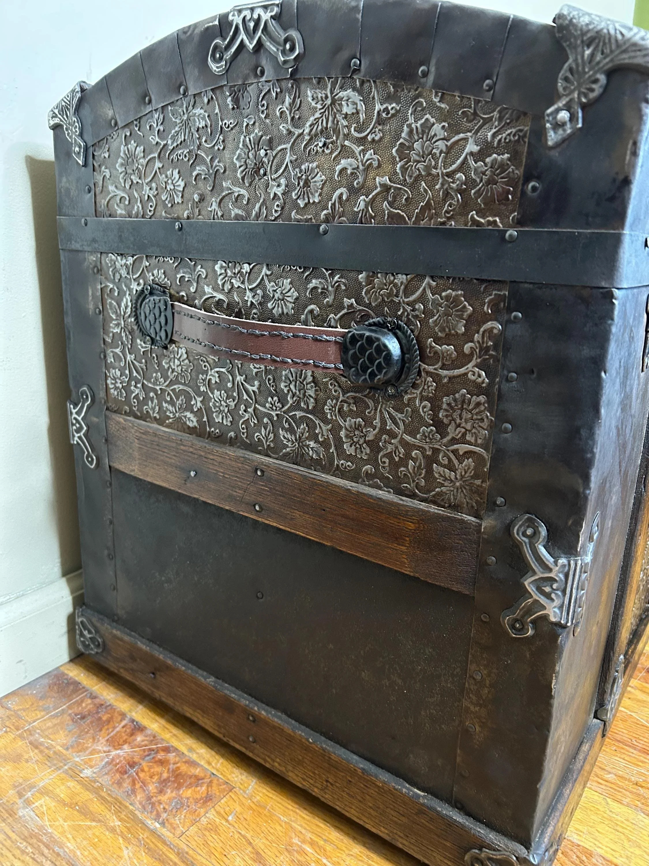 Hand-polished original metal hardware and rivets on a high-end heritage chest.