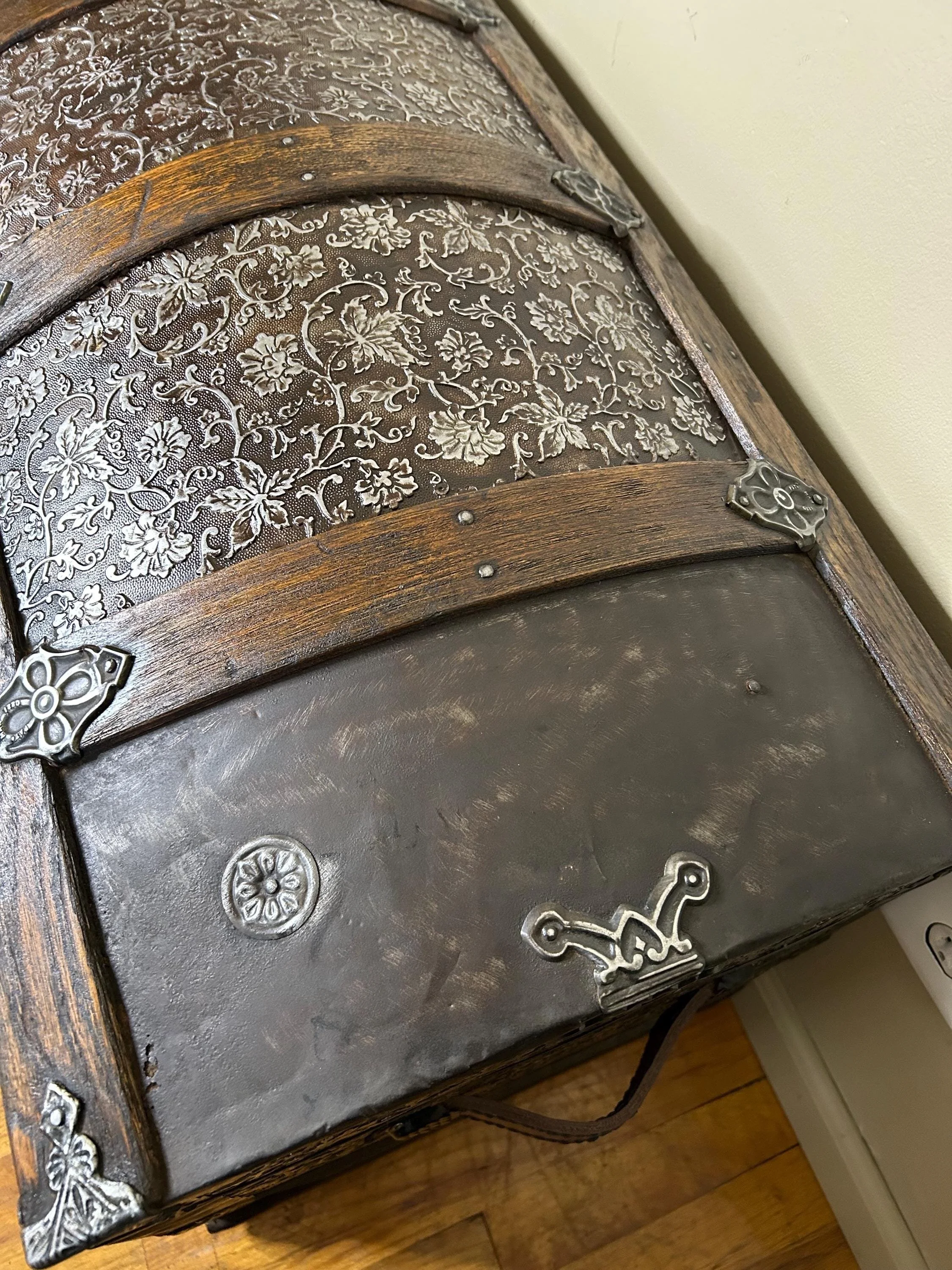 Refined walnut finish on solid oak wood slats of a restored 1800s travel trunk.