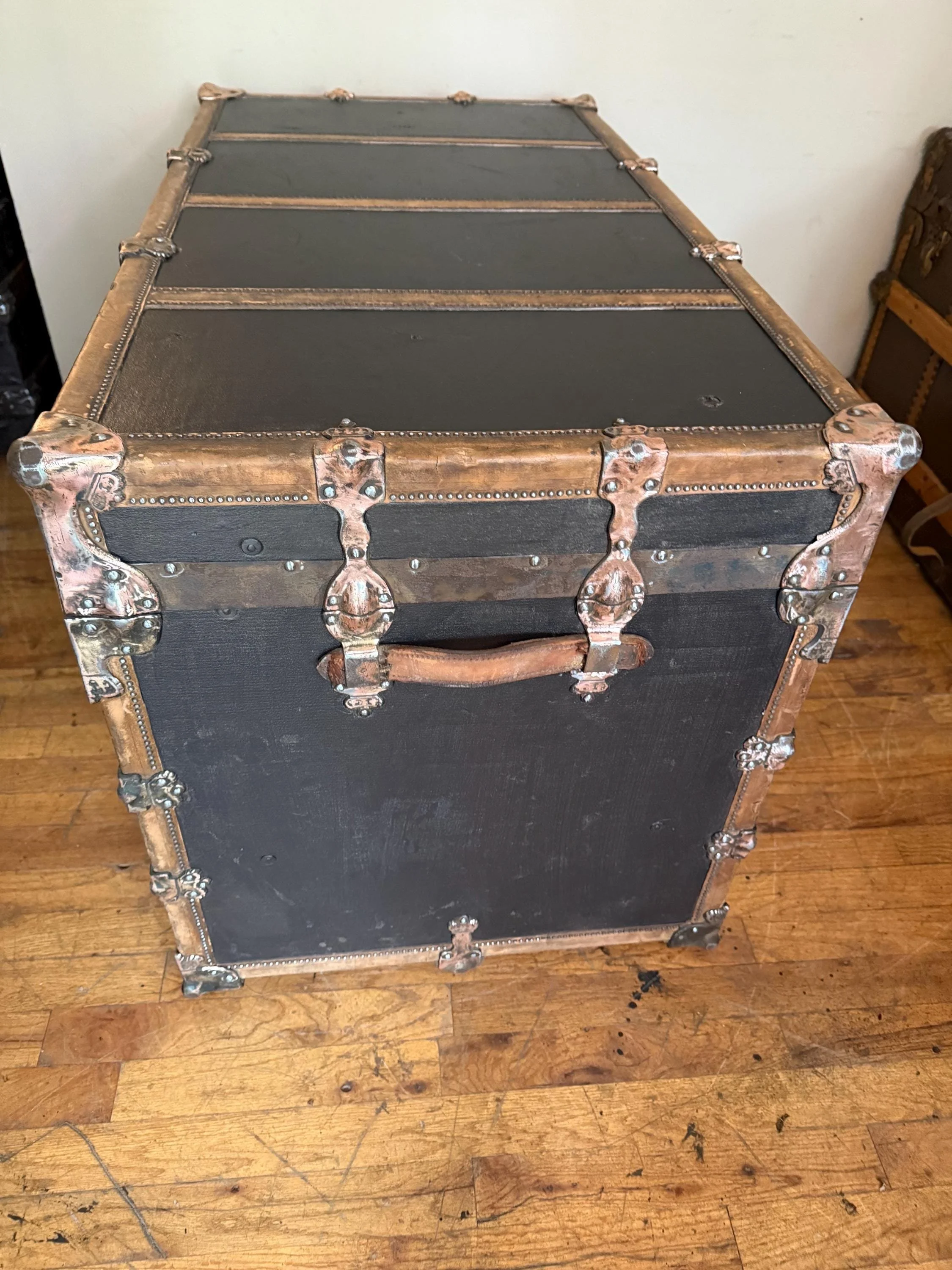close-up of the textured vinyl and leather trim on a refinished extra-large trunk.
