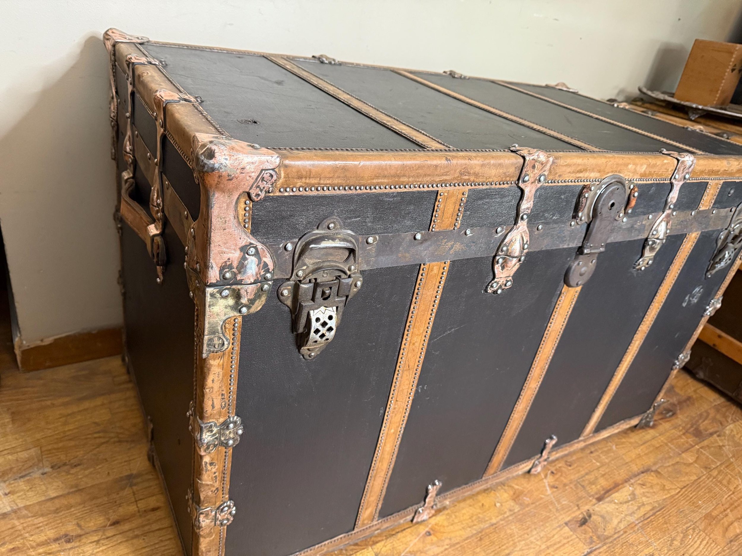Front view of a massive 41" travel trunk professionally curated for home decor.
