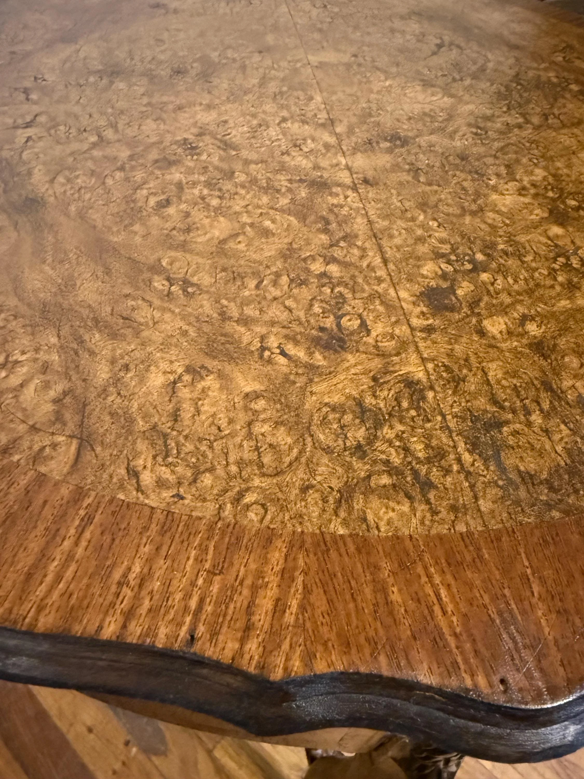 Top-down view of a rare burl wood surface showing intricate natural timber patterns.