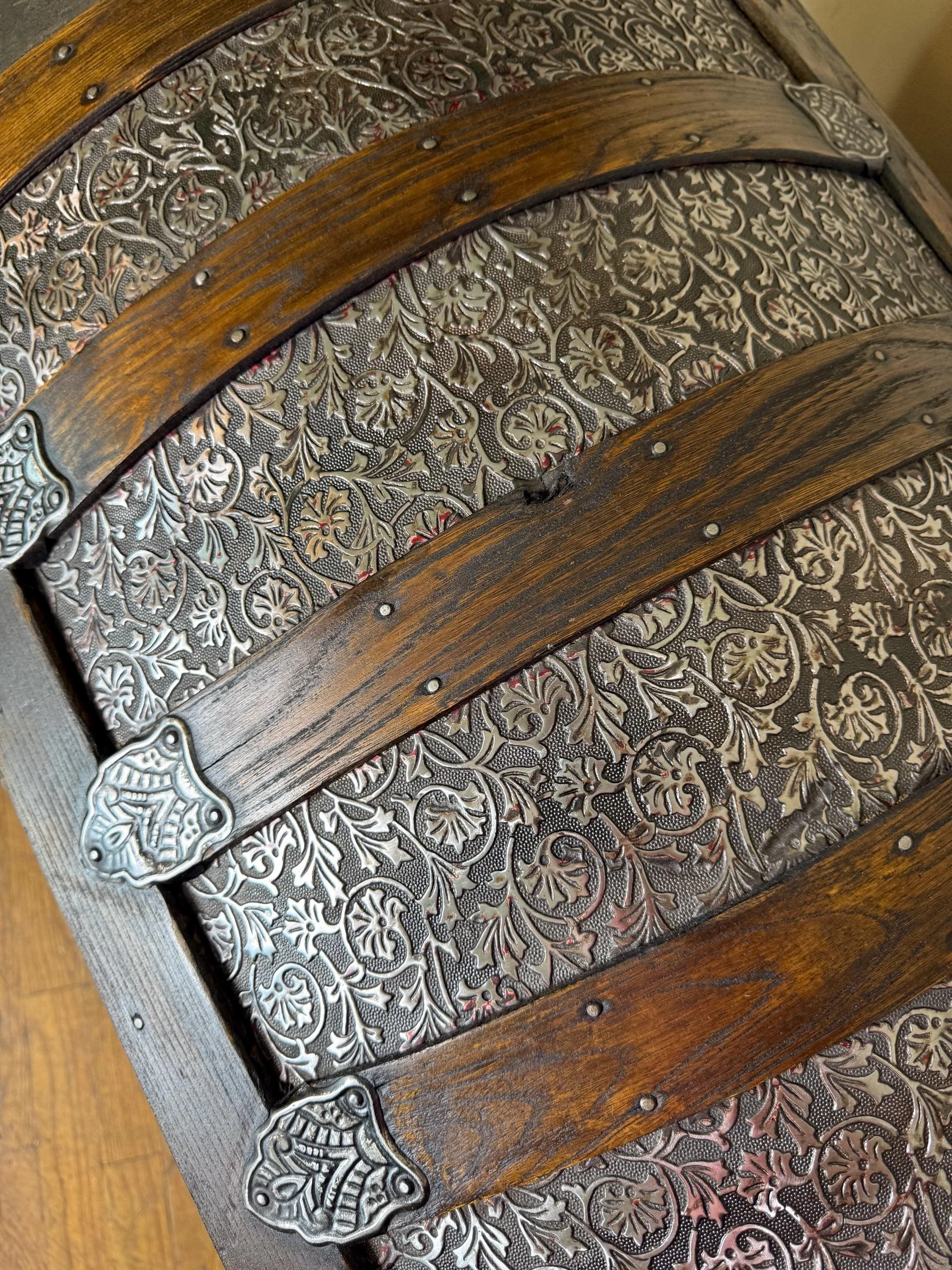 Refined walnut finish on solid oak wood slats of a restored heritage travel trunk.