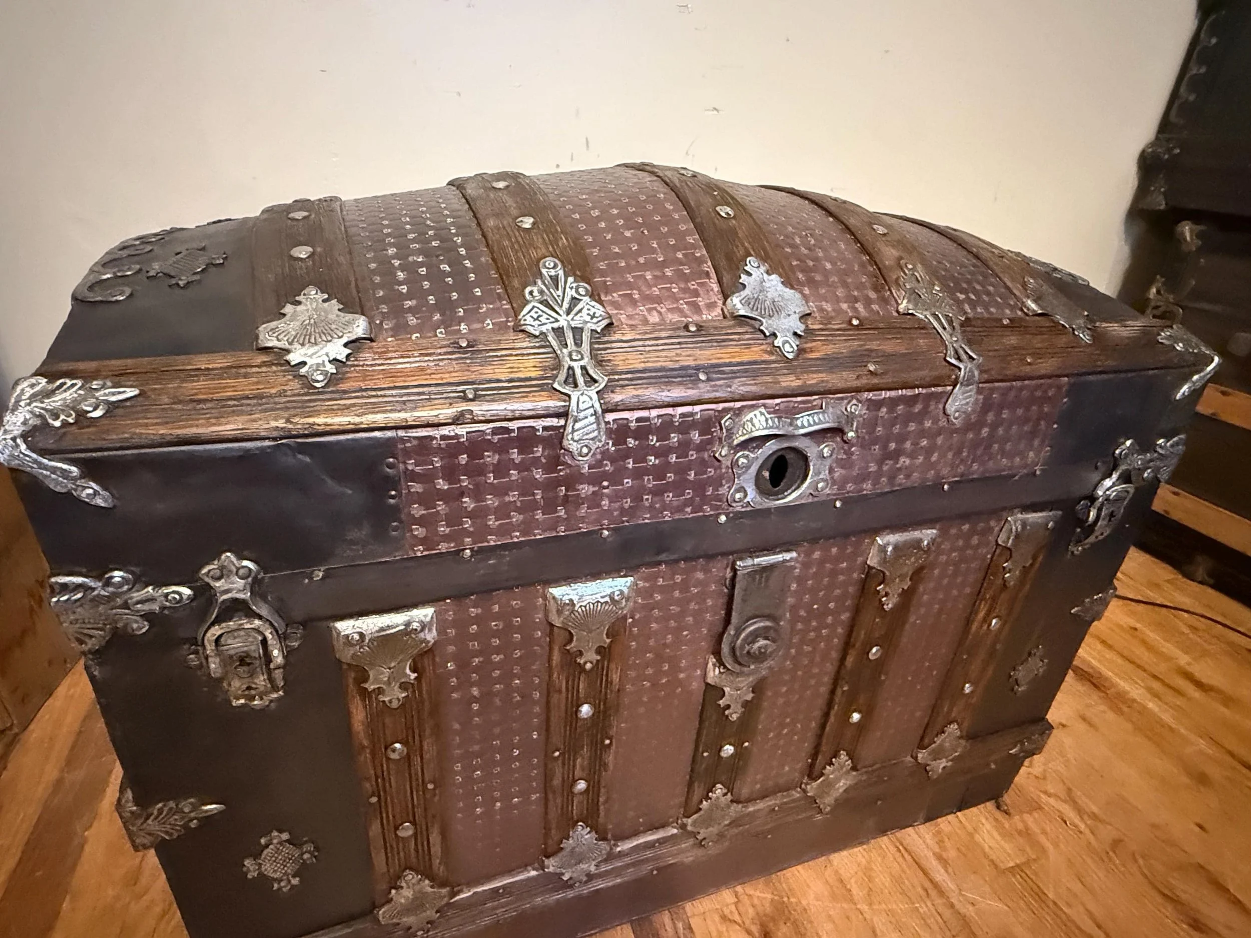 Museum-quality rare tin Saratoga trunk providing deep, clean storage for modern homes.