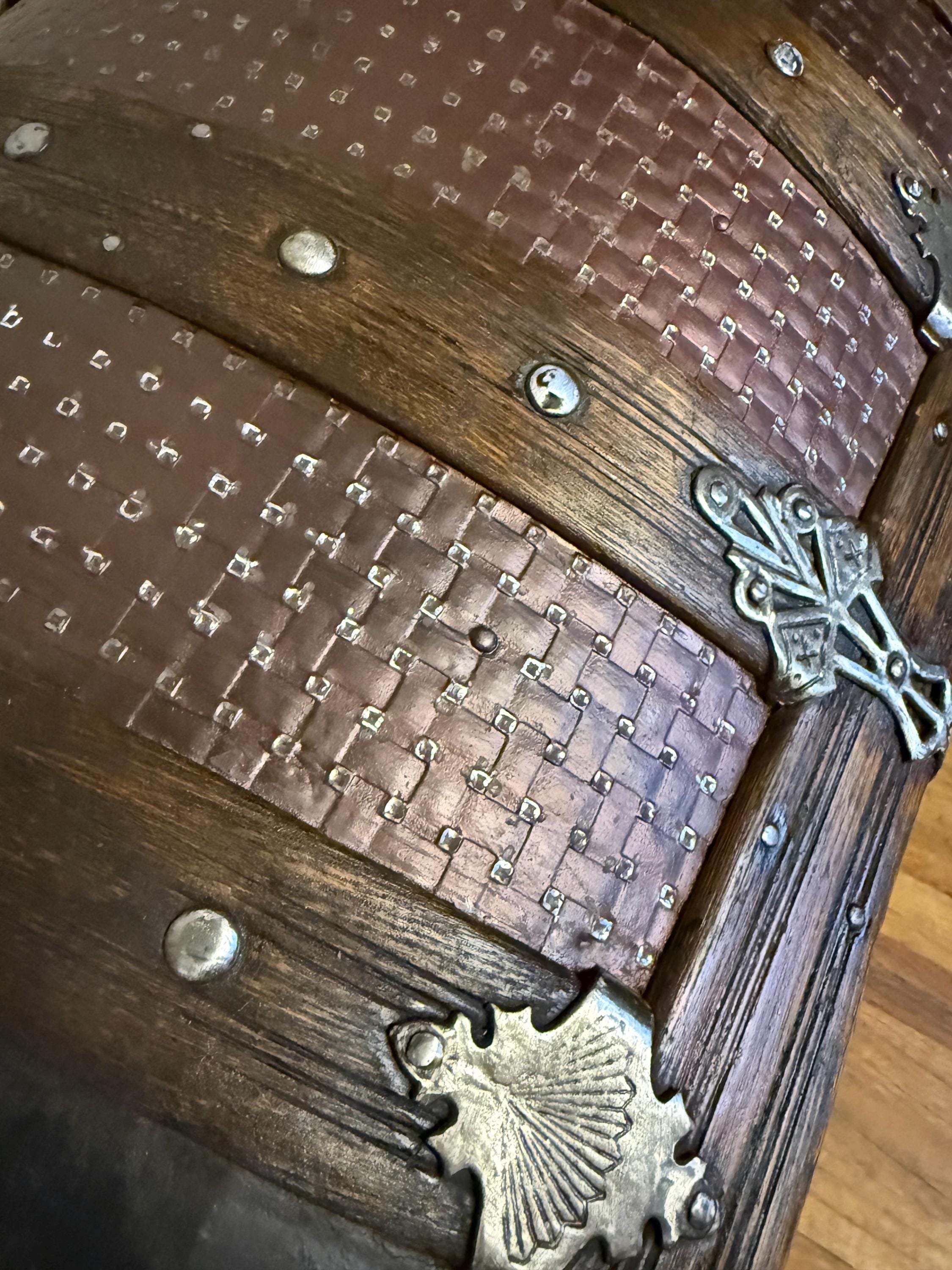 Detailed close-up of the rare basketweave relief pattern on a refinished antique trunk.