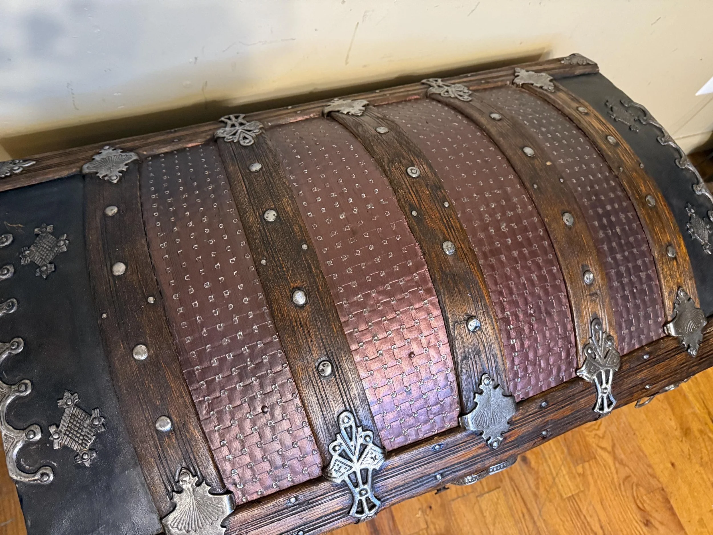 Top-down view of the textured basketweave metal cladding and wood slats.