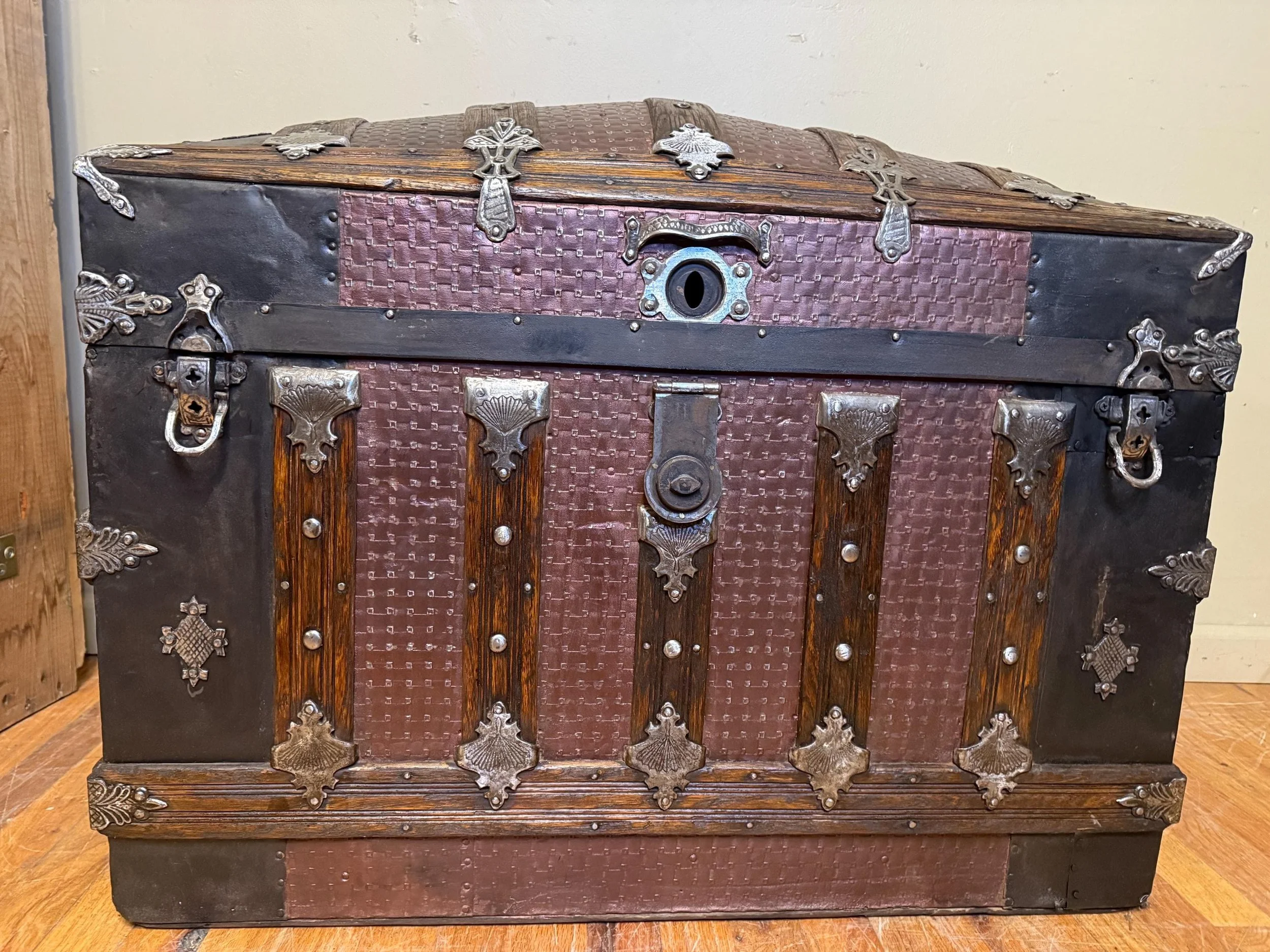 An 1800s travel trunk repurposed as a luxury statement piece in a Victorian Gothic interior.