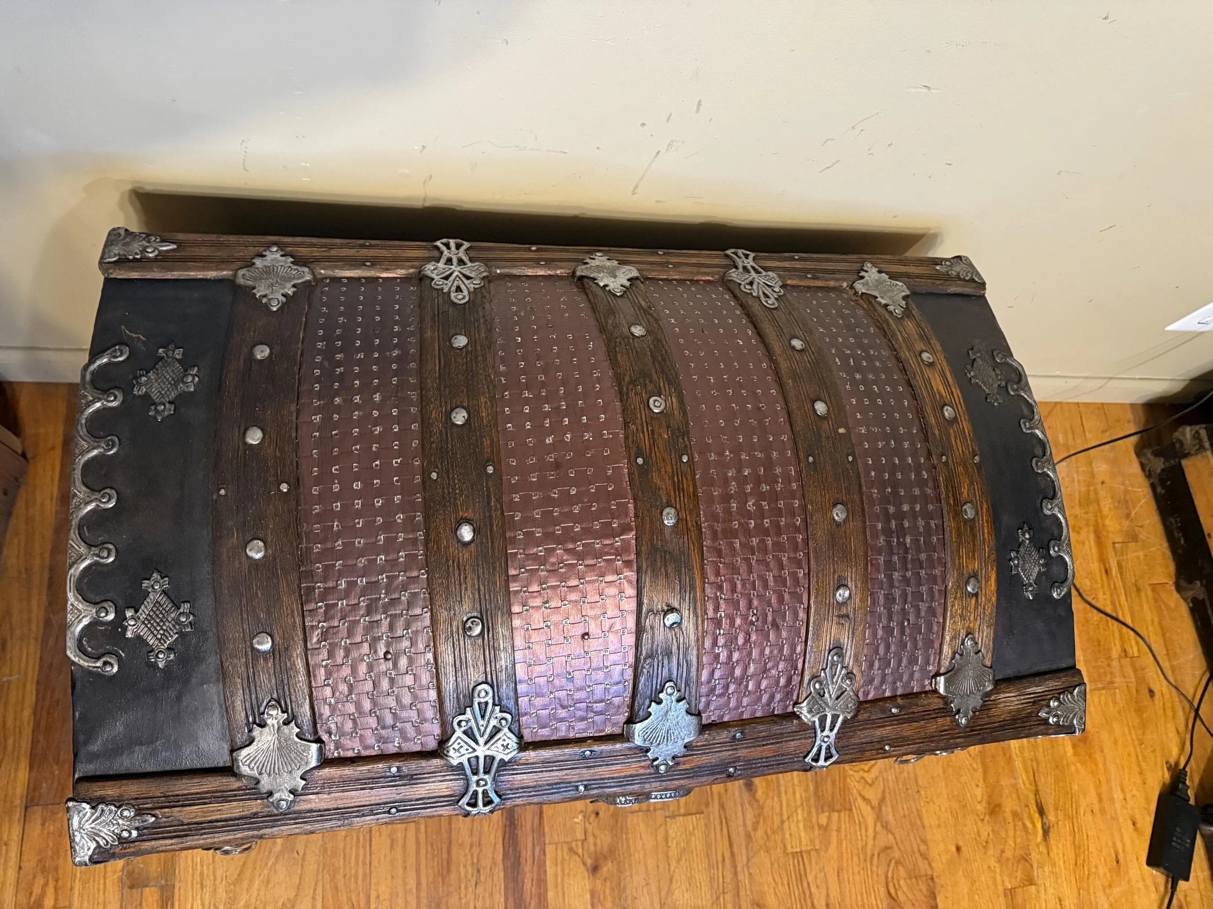 Iridescent black cherry paint shift on a professionally refinished Victorian storage chest.
