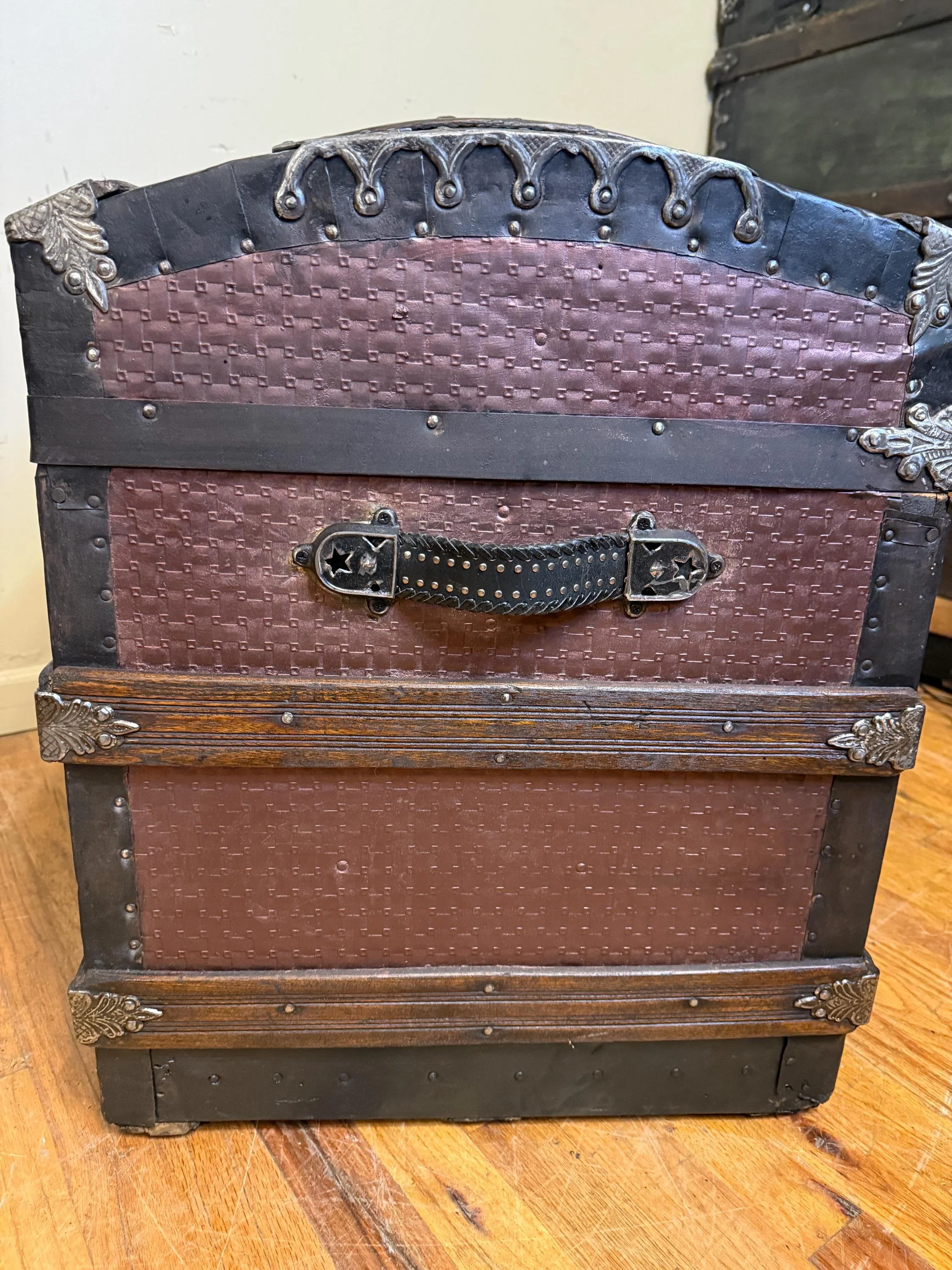 Side profile highlighting the high arched dome top lid and architectural metallic silhouette.