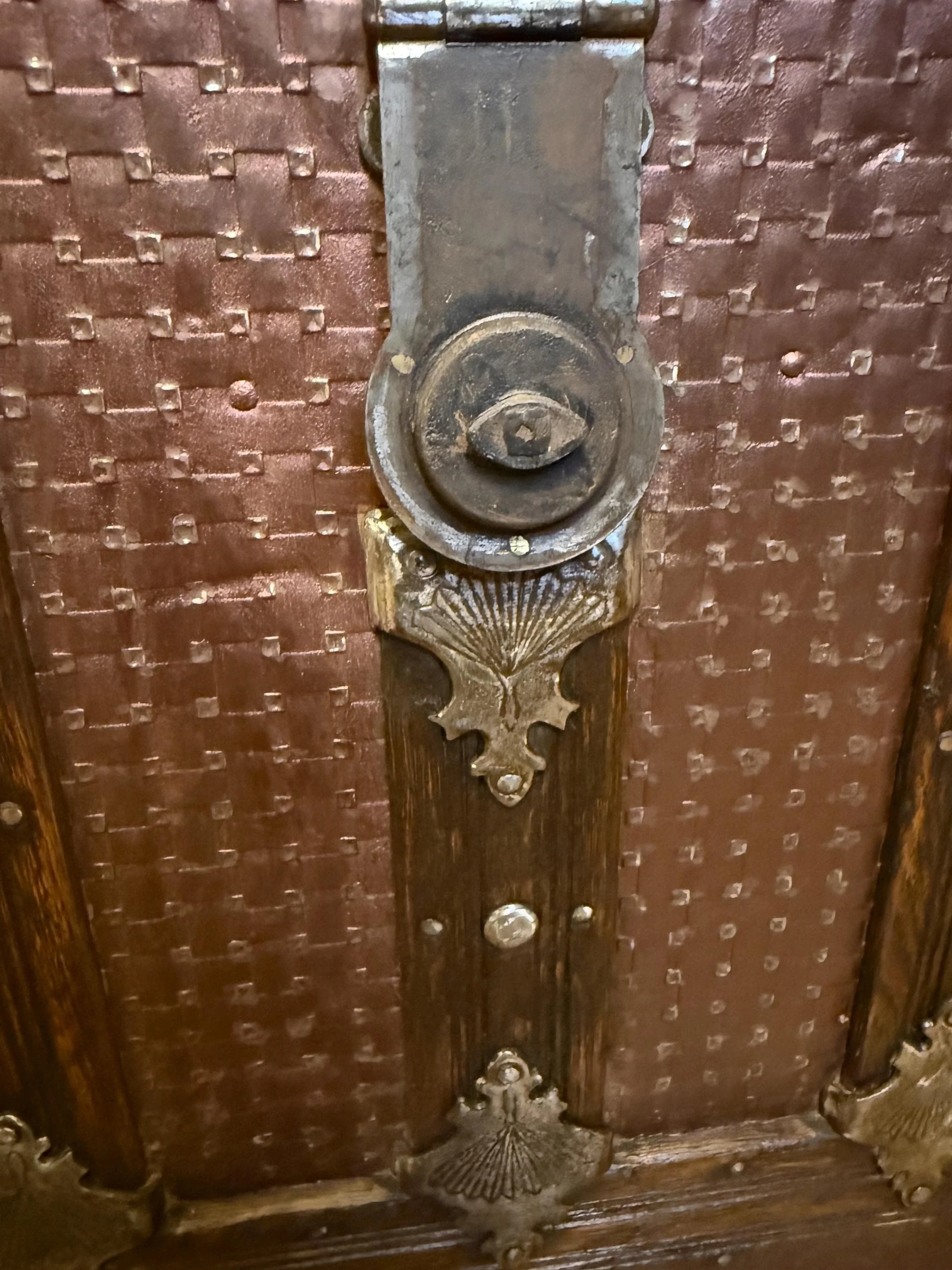 Detailed view of the original antique lock hasp and polished decorative hardware.