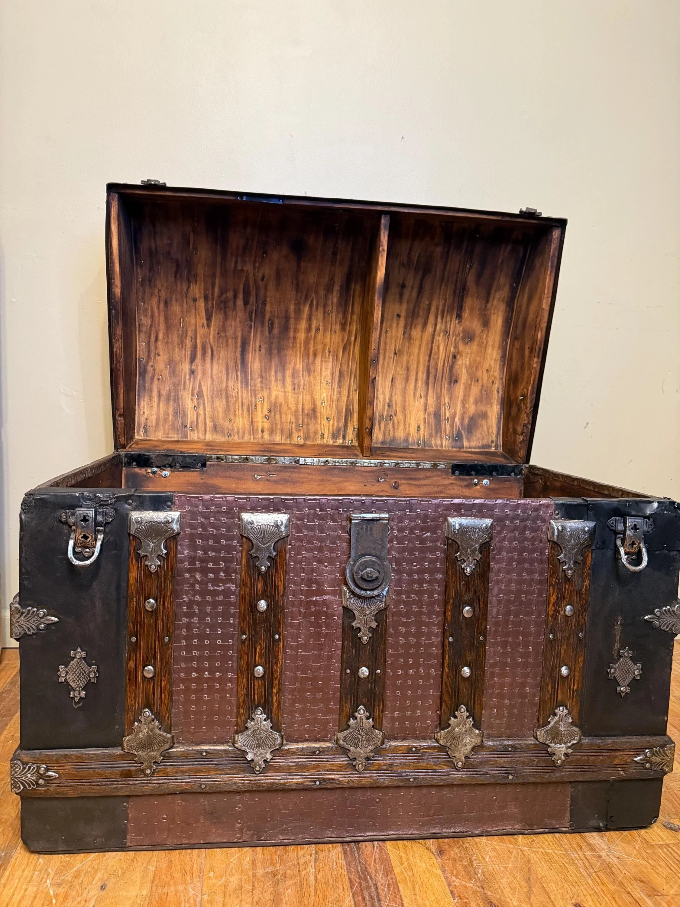 Wide shot of the open trunk showcasing the contrast between cherry paint and torched wood.
