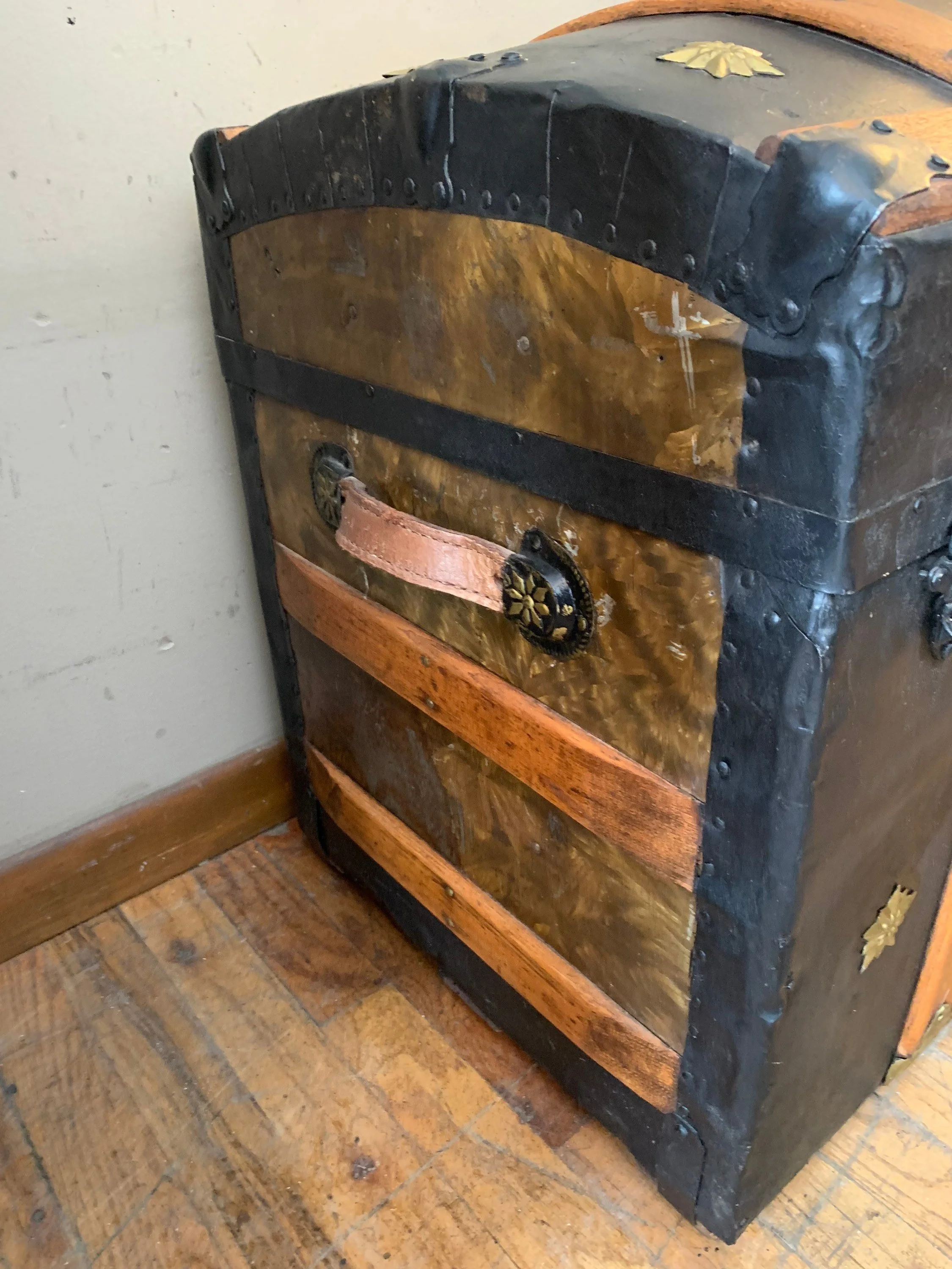 Side view showing newer durable leather handles on a large 19th-century heritage trunk.