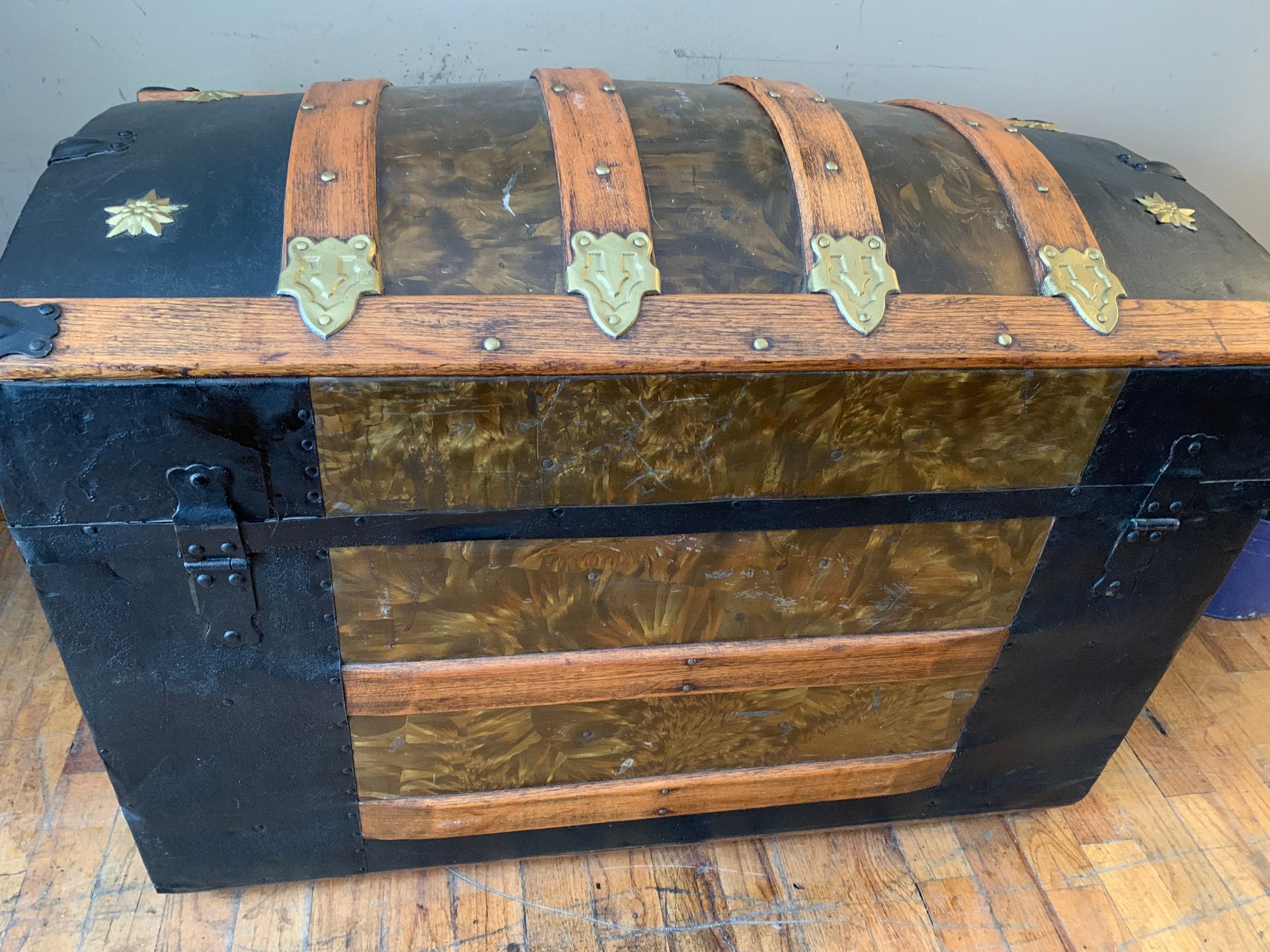 Rear view showing the original metal hinges and structural integrity of the wood and tin cladding.