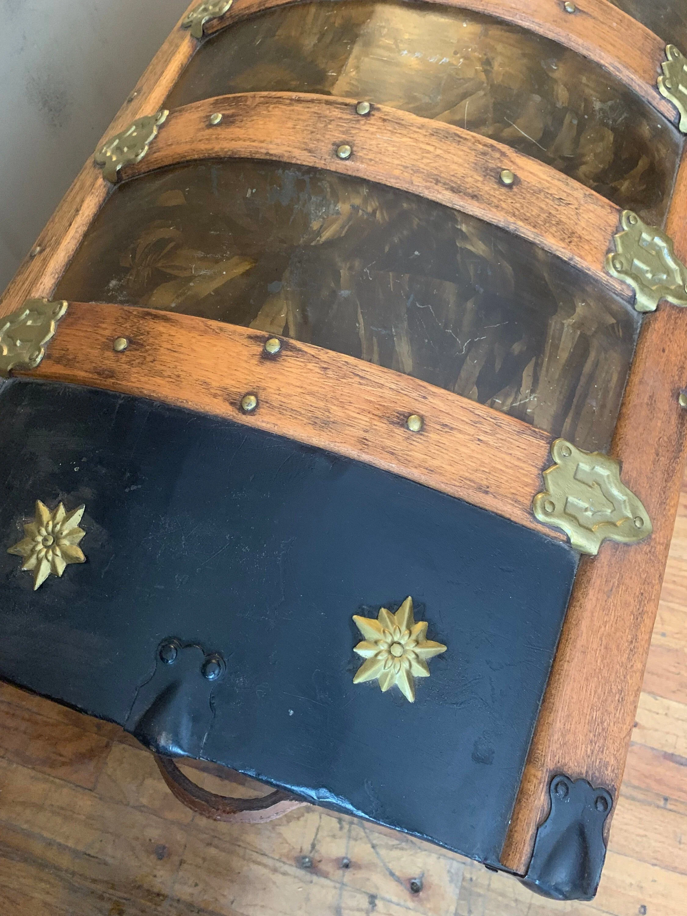Detailed view of hand-polished brass-tone hardware and original metal rivets on a travel chest.