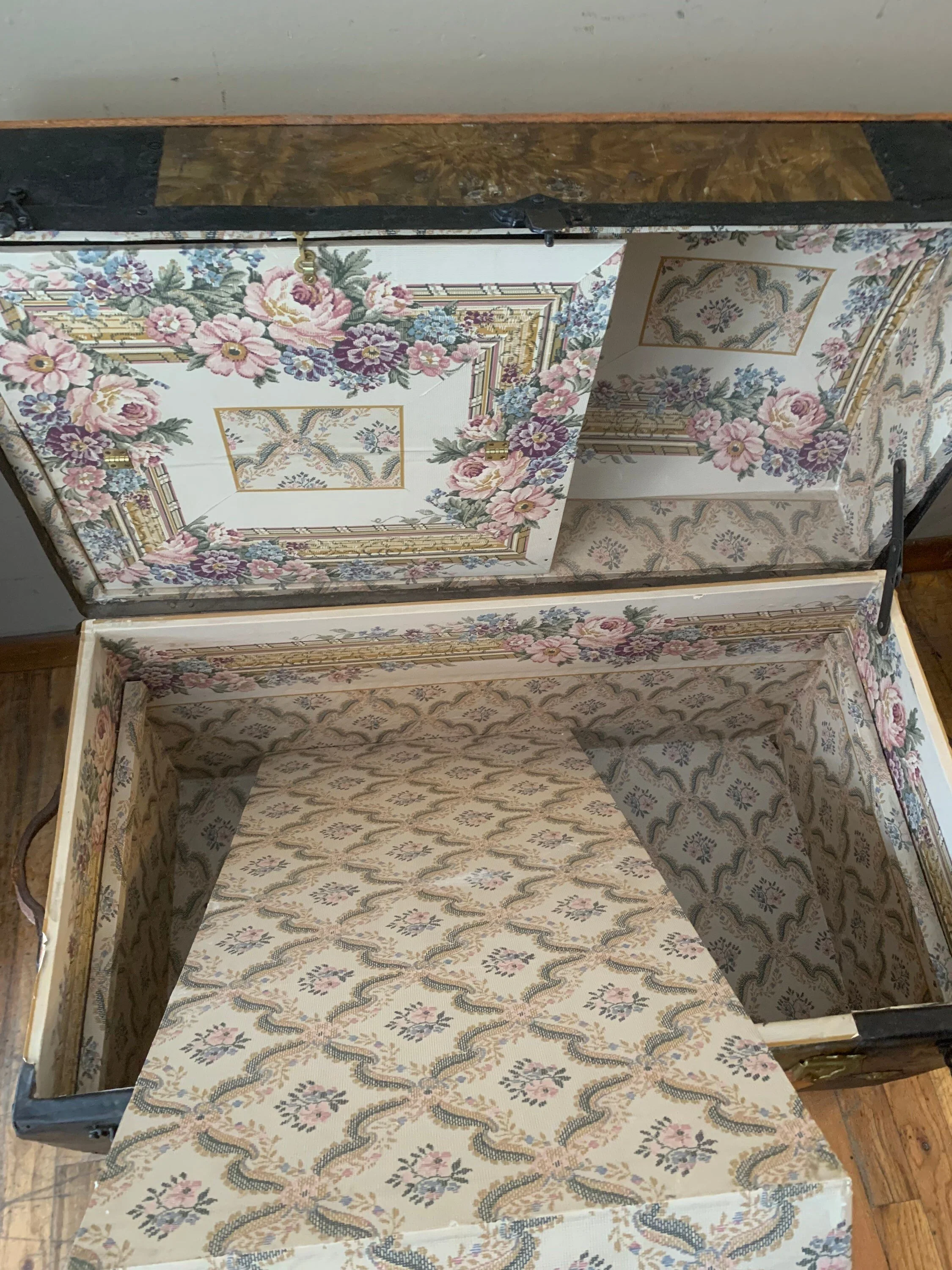 Inside view of a sanitized, odor-free antique trunk interior redone with decorative lining