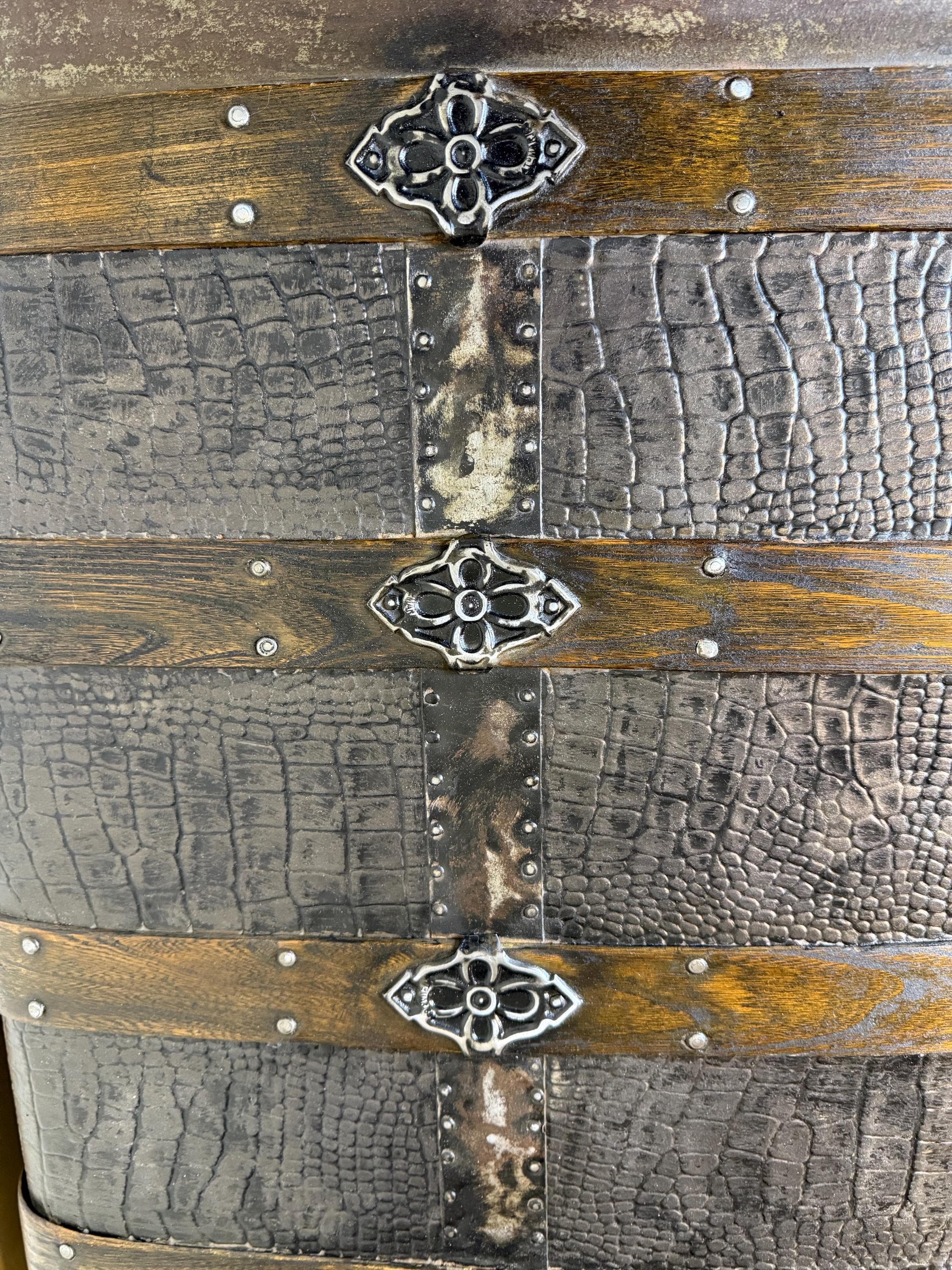 Hand-polished metal hardware and rivets on a 19th-century heritage chest.
