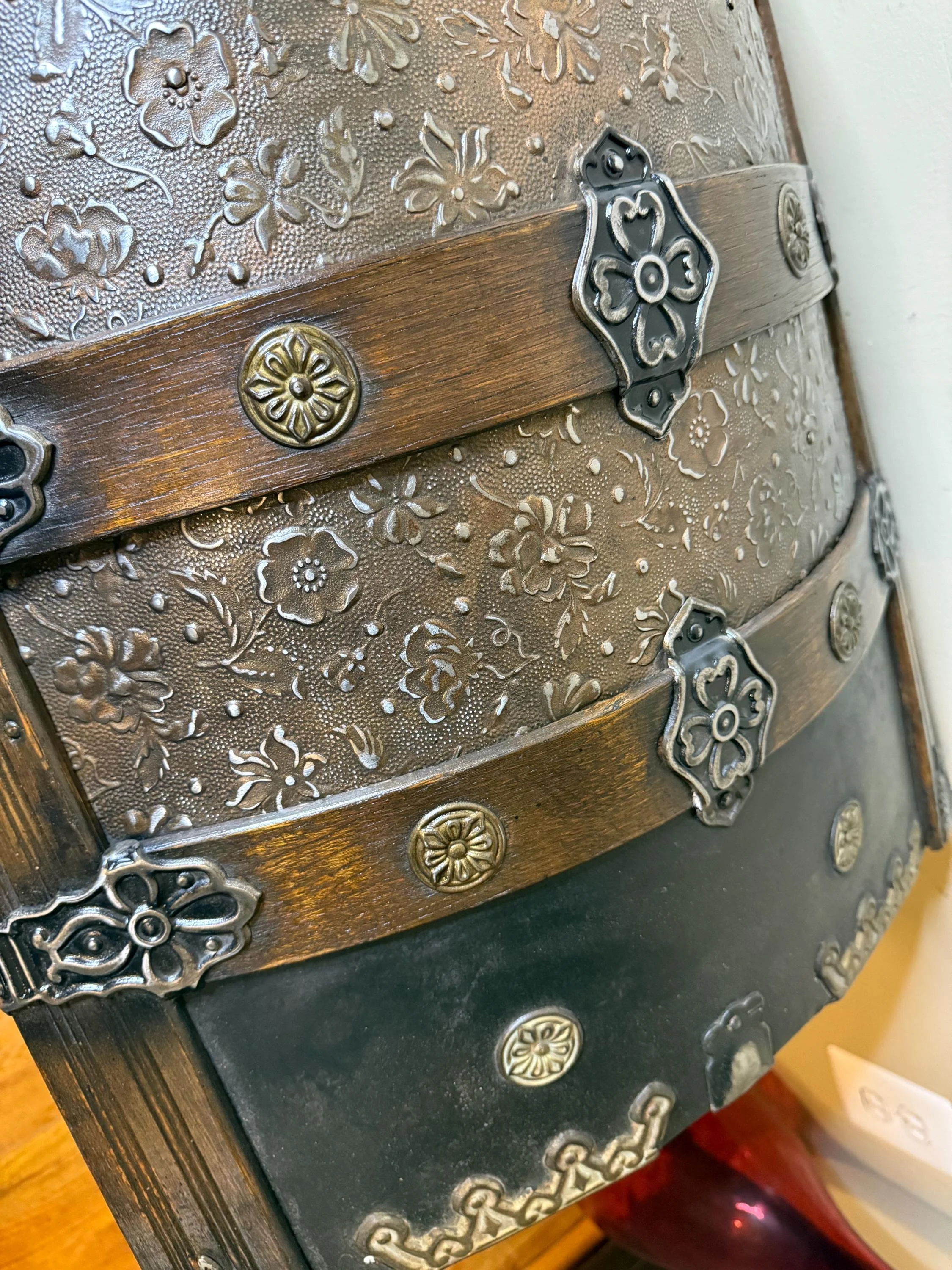 Close-up of floral embossed tin pattern on humpback trunk