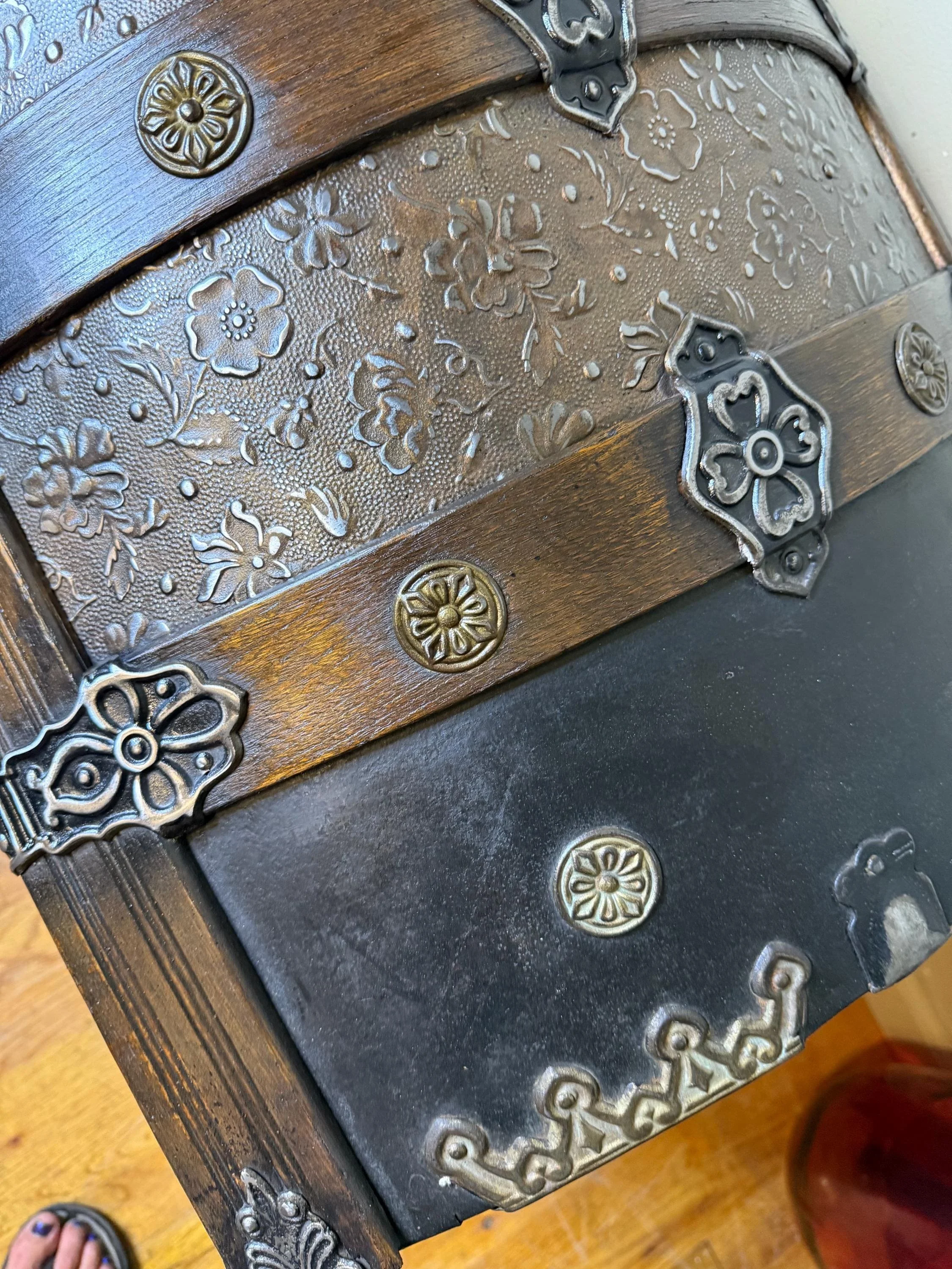 Lid detail showing rivets and hardware on Victorian steamer trunk