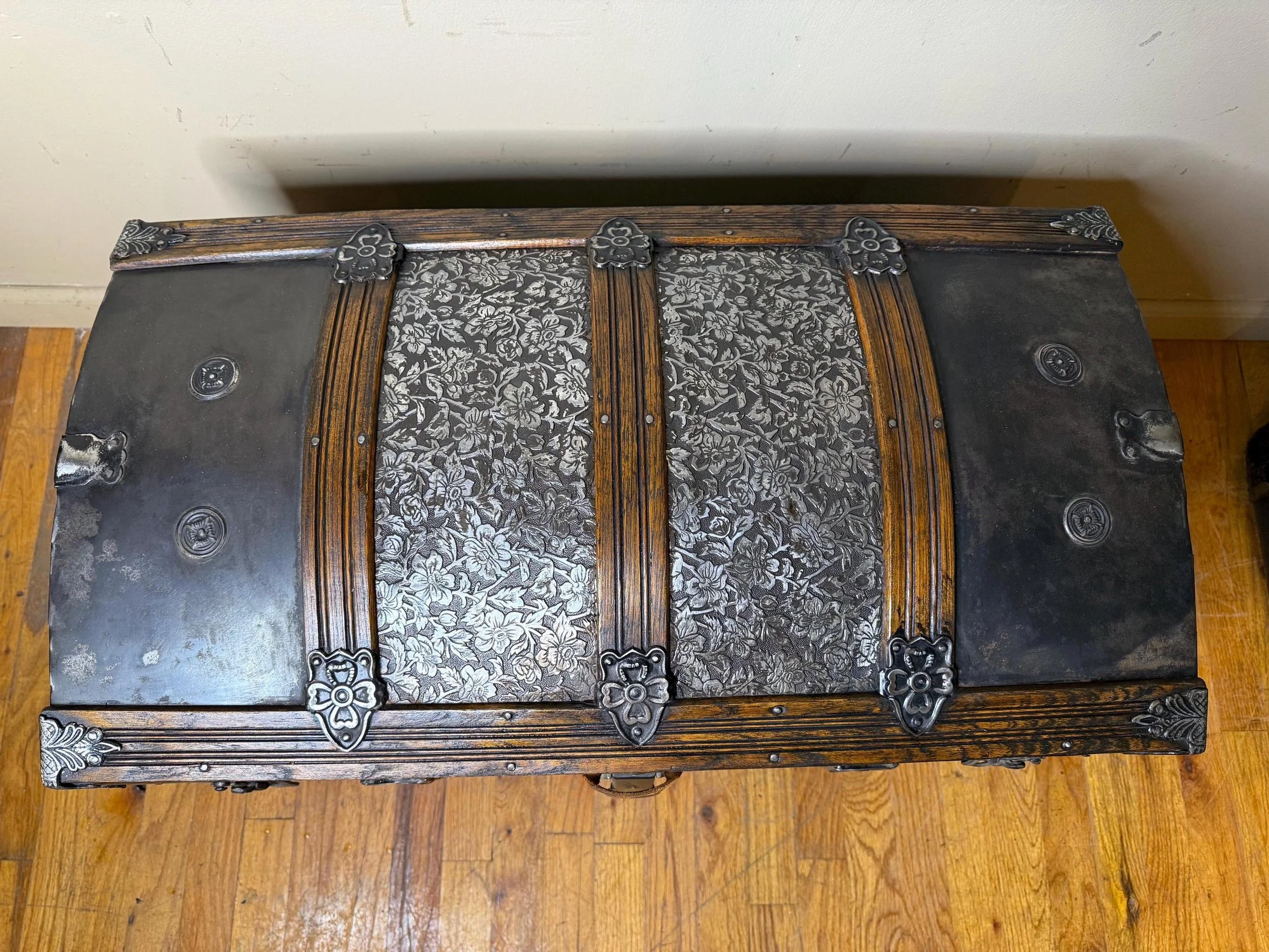 Solid oak wood slats with a walnut finish on a restored humpback treasure chest.