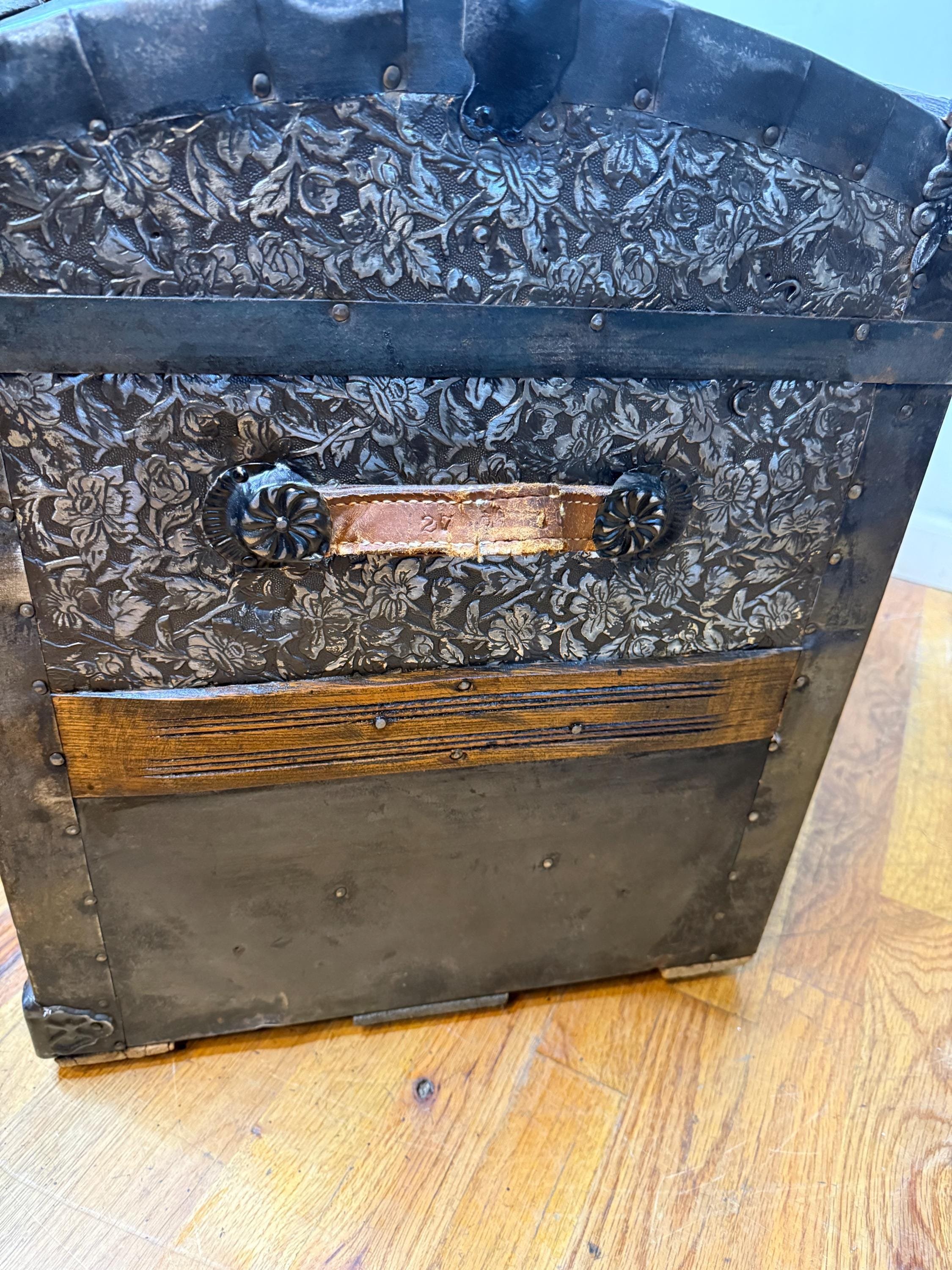 Side profile highlighting the high arched dome lid of a 19th-century travel trunk with original handles