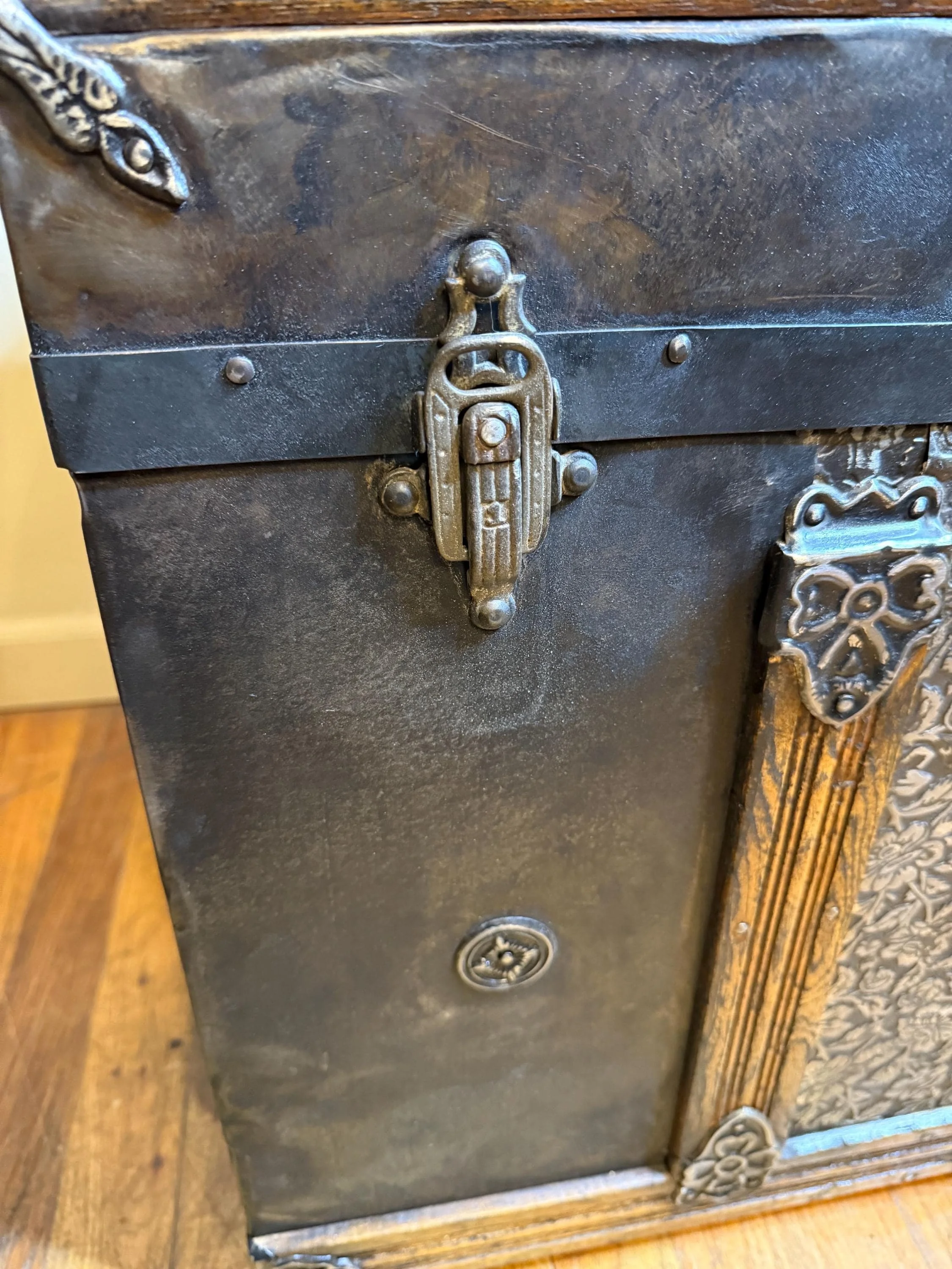 Macro shot showing the high-relief blossom patterns on the buffed bright tin, curated and revitalized by specialist Angelina Nikon.