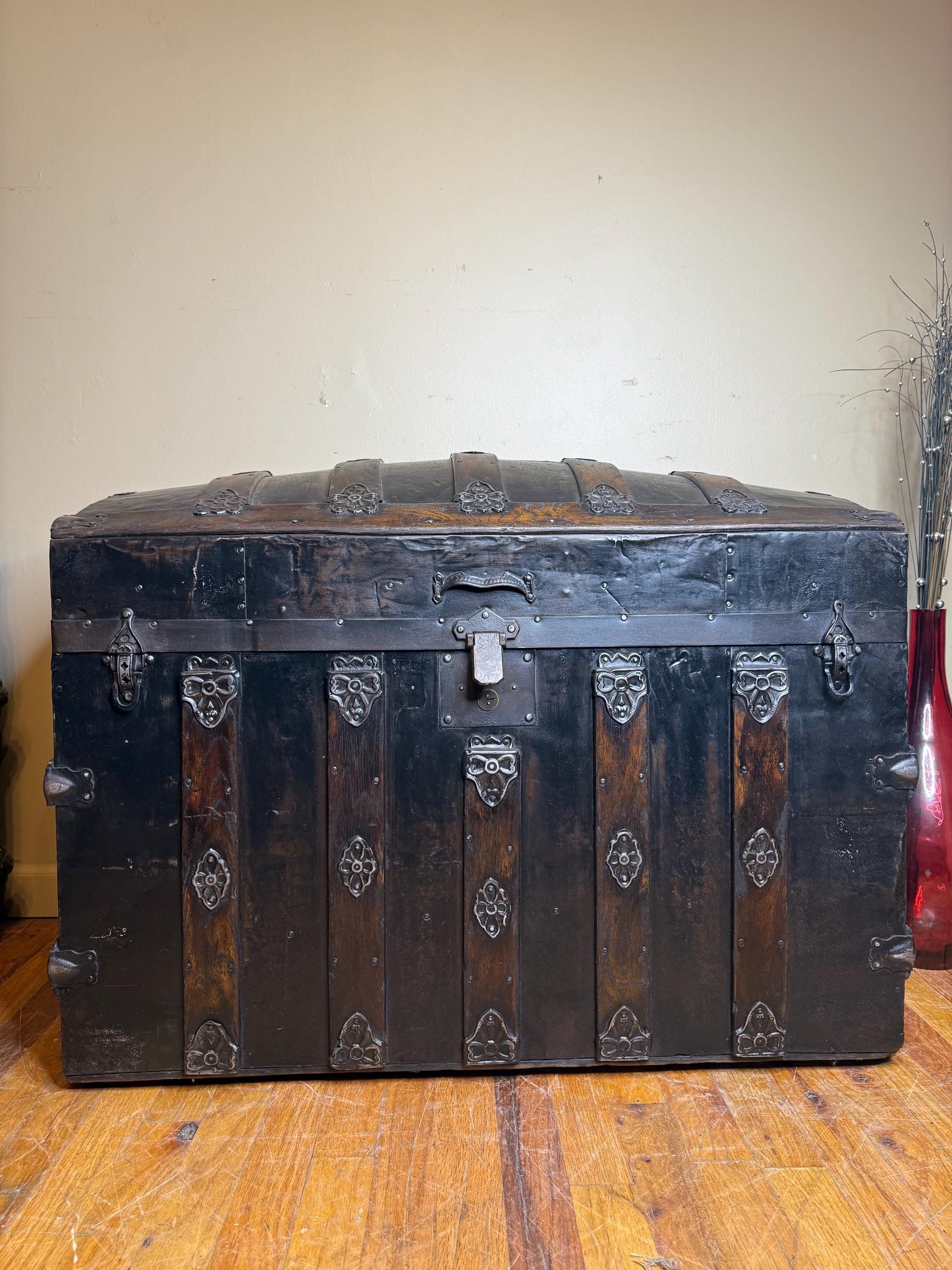 Arch-top antique steamer trunk front view