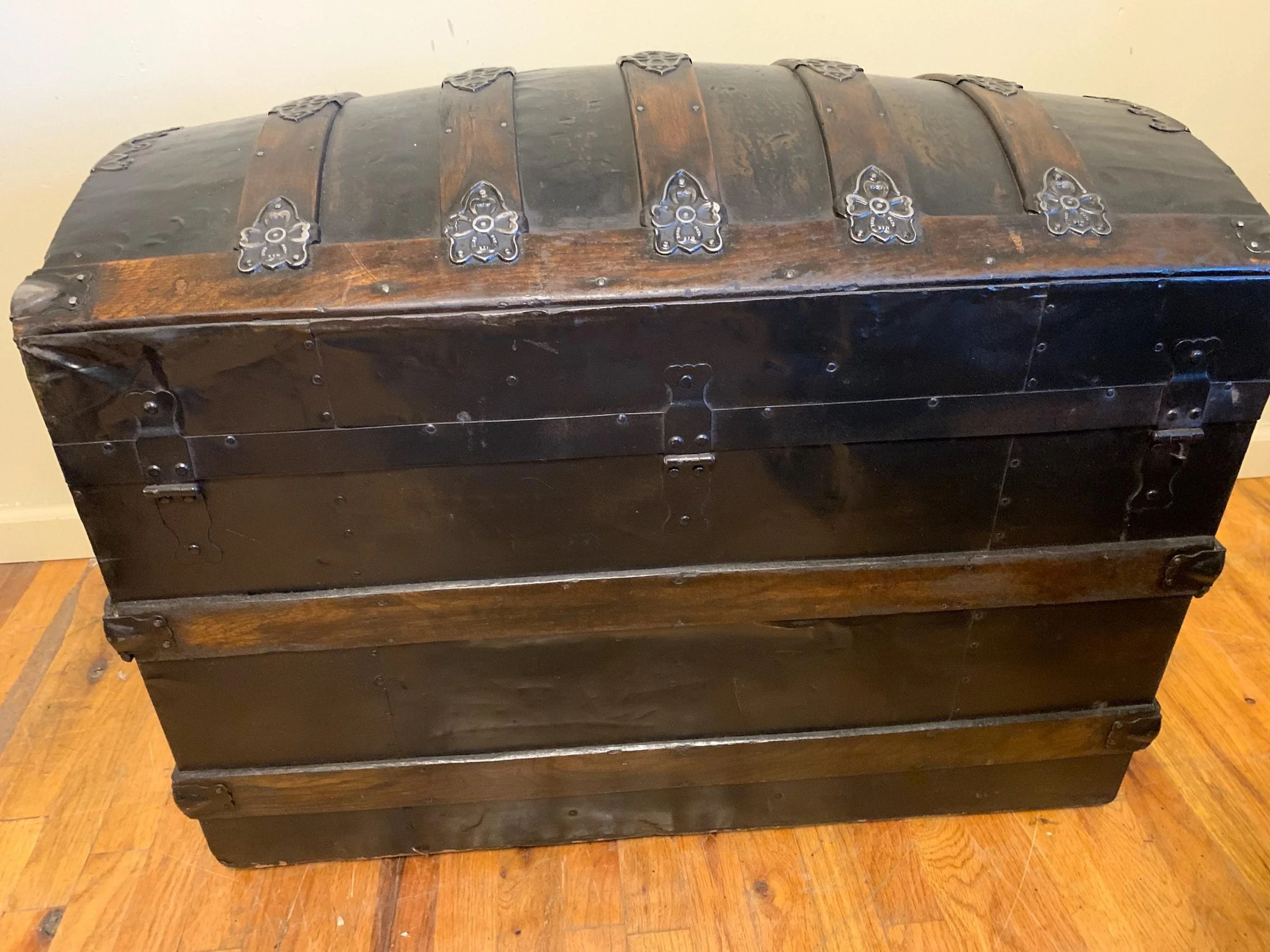 Large antique steamer trunk showing curved lid profile