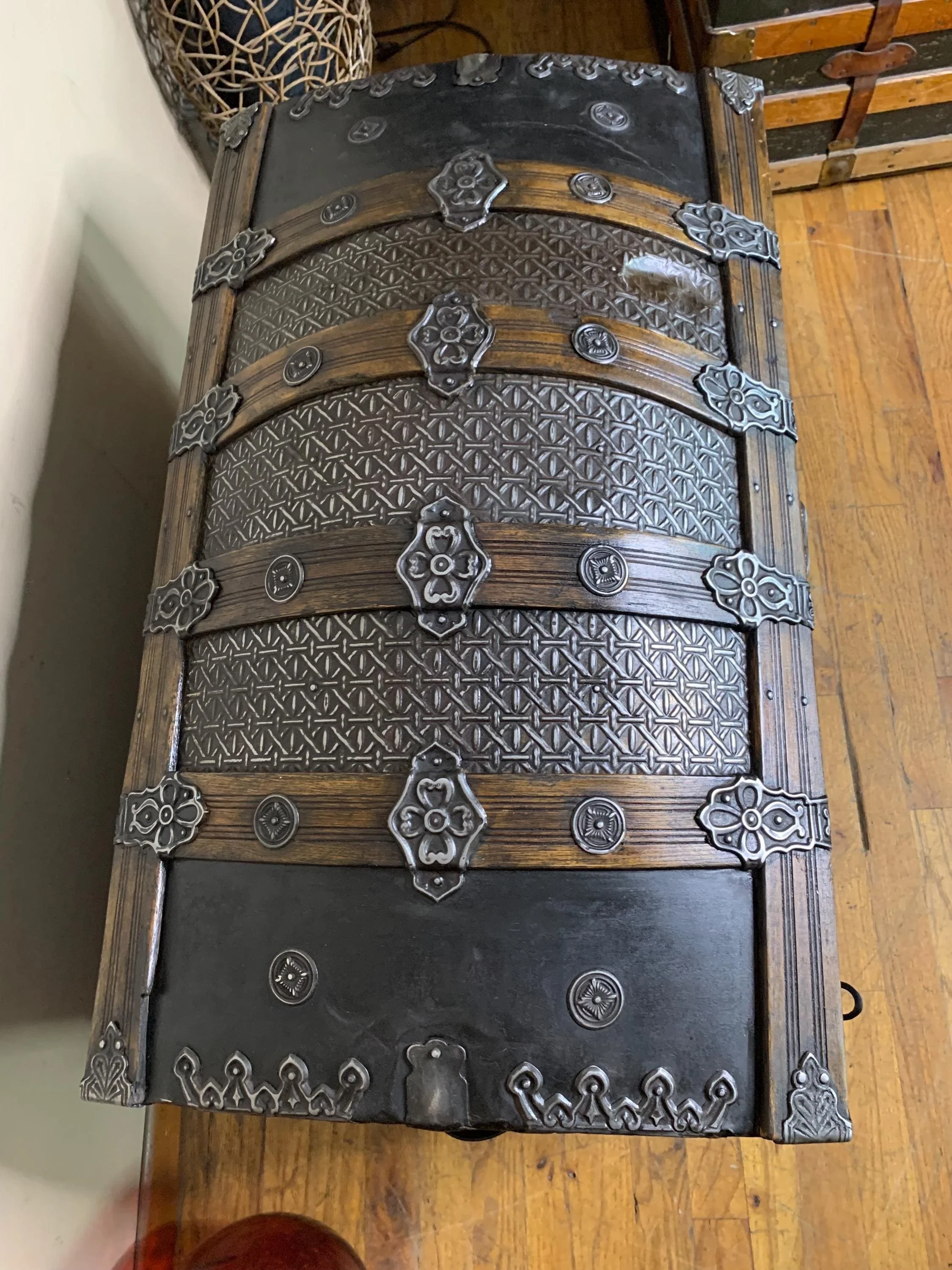 Detailed close-up of the rare high-relief embossed tin pattern on an 1800s steamer trunk.
