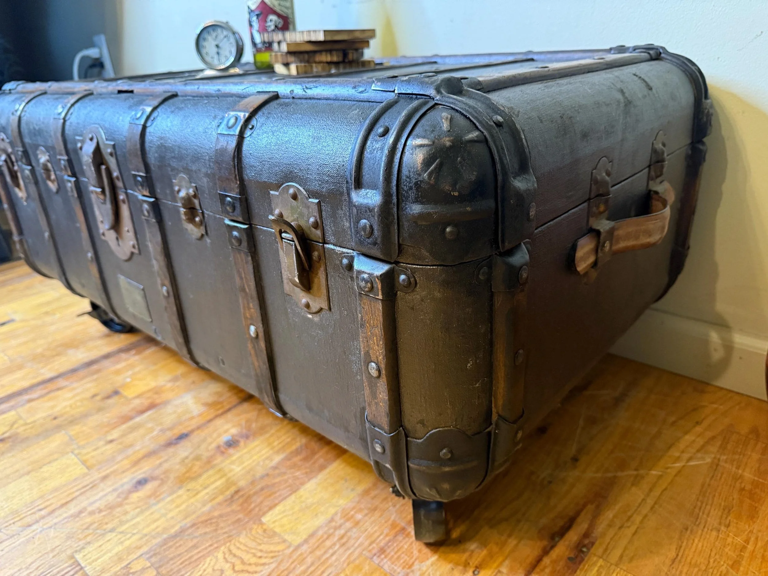 Hand-polished original hardware and metal rivets on a restored Indestructo chest.