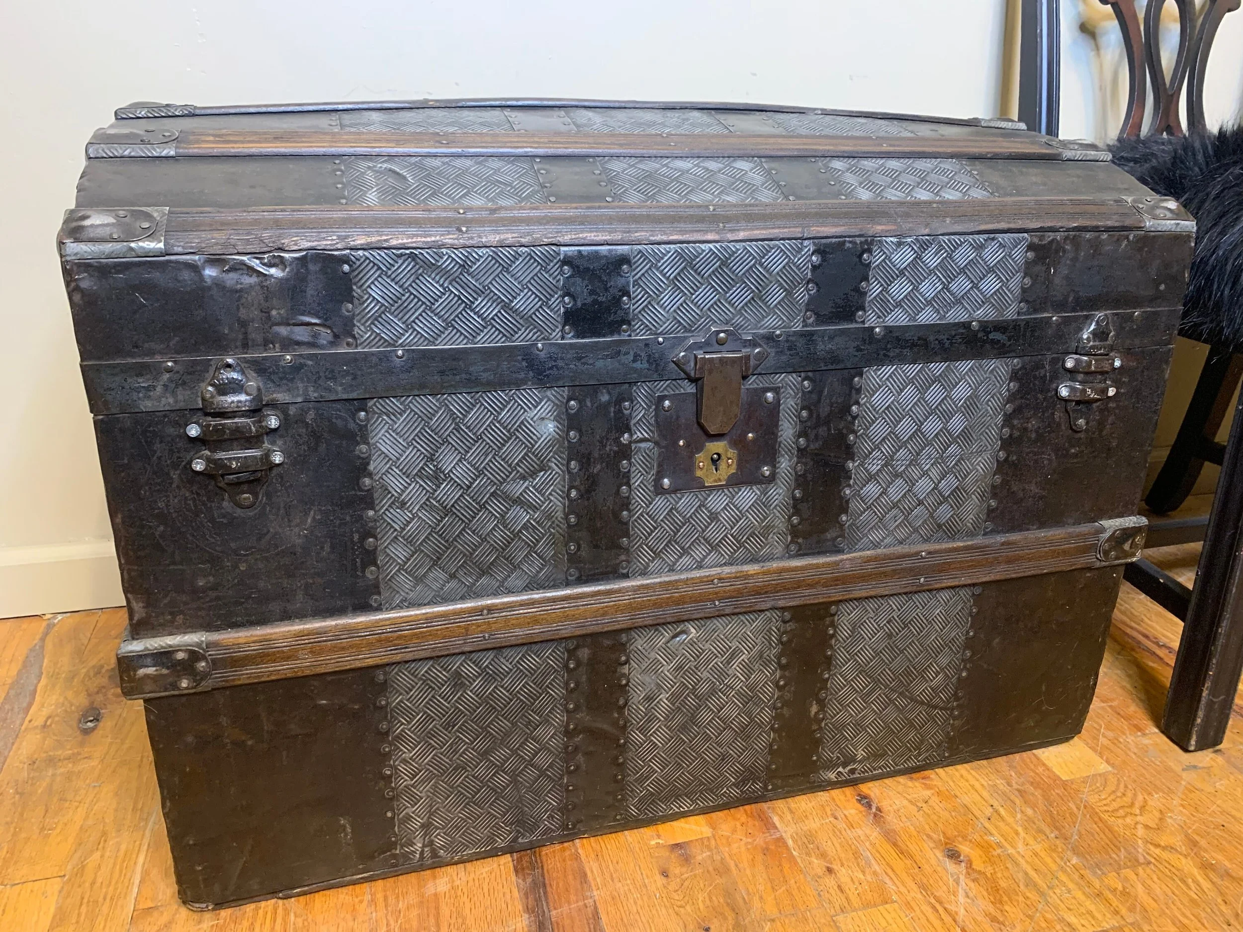 Antique steamer trunk with crosshatch embossed tin exterior