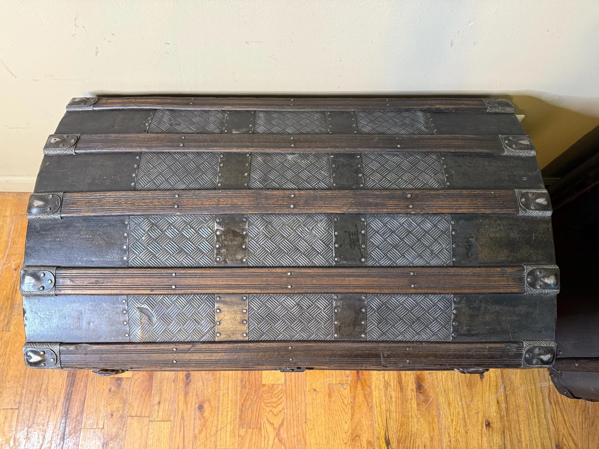 Industrial style hardware on vintage antique trunk
