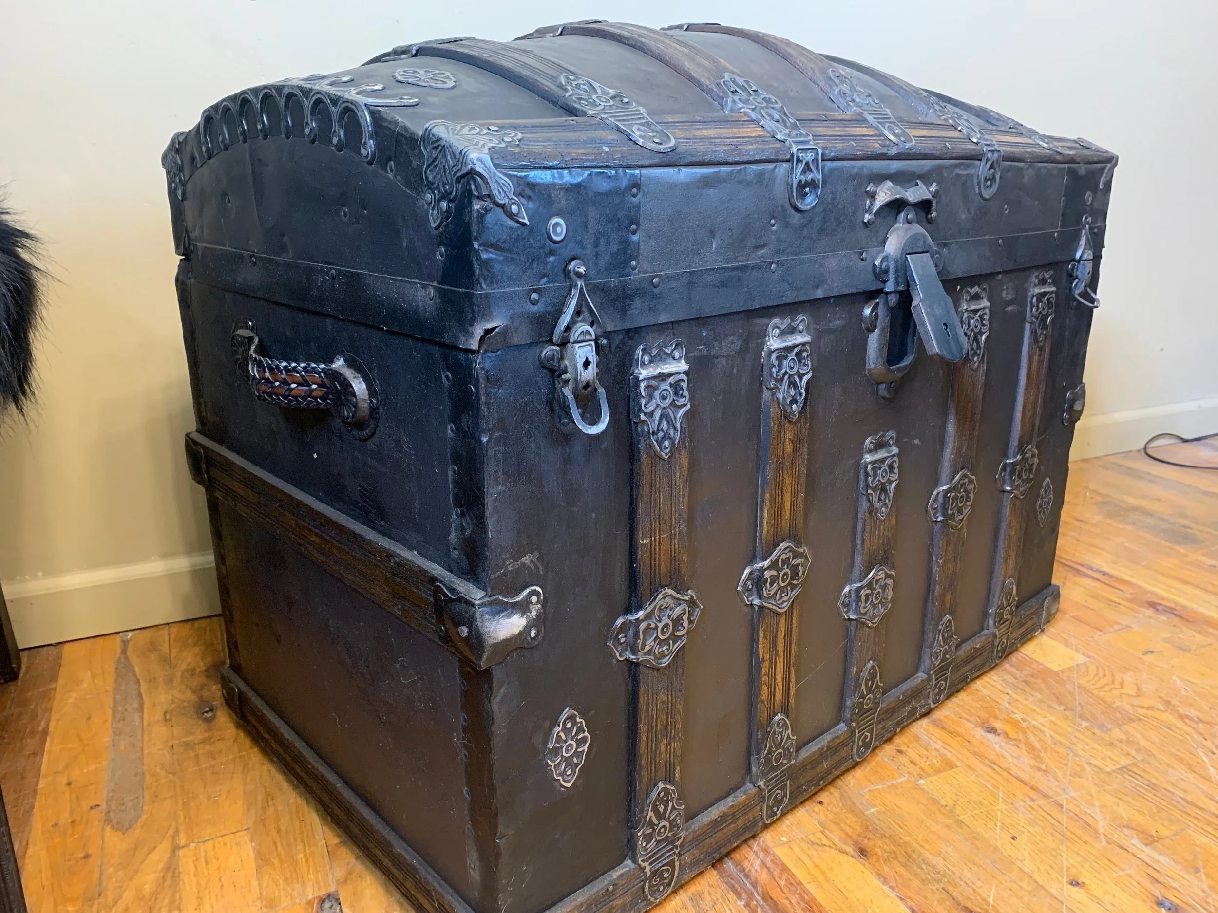 Refinished antique storage trunk with aged brown and black finish