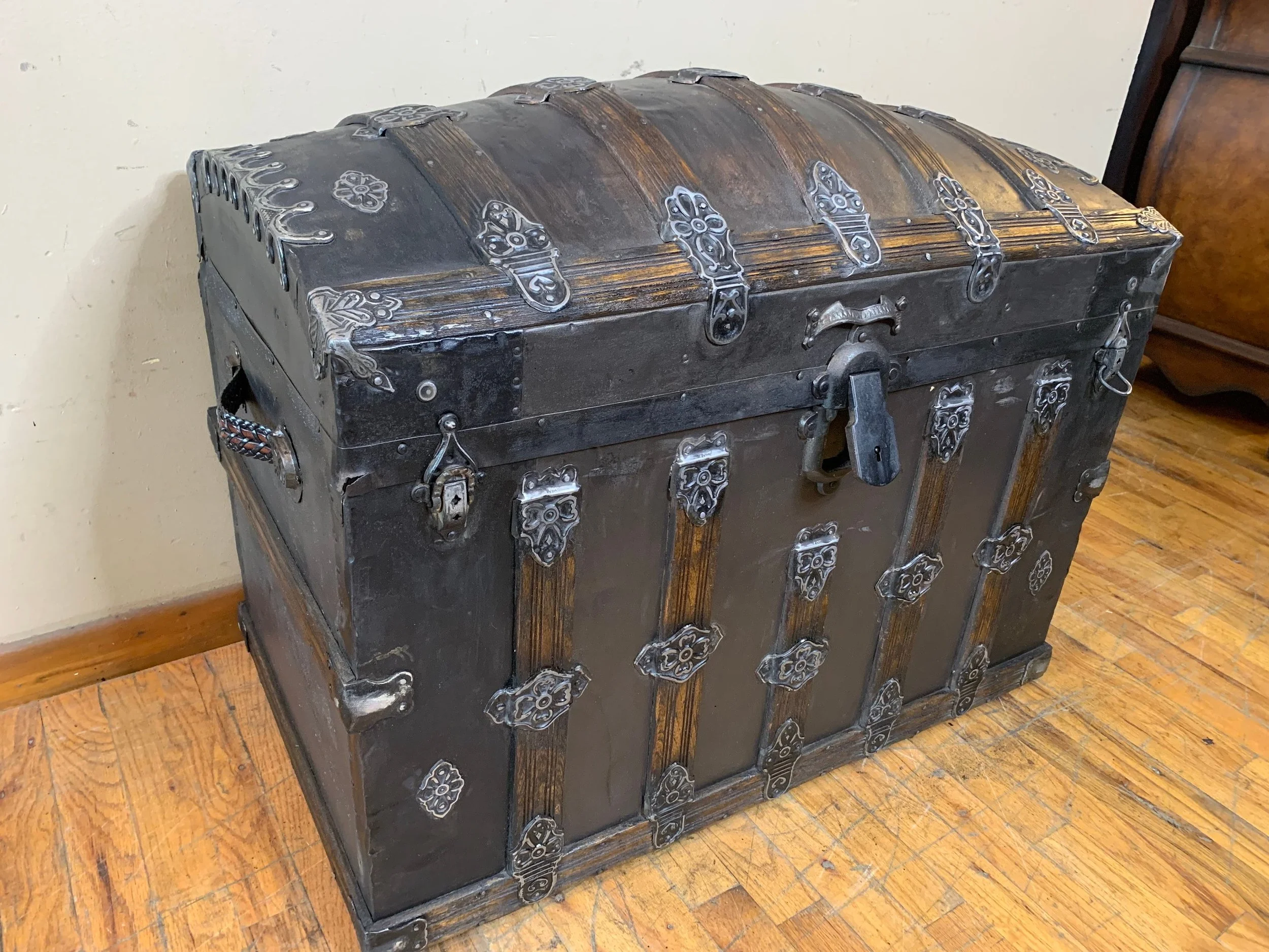 Large antique dome top steamer trunk with refinished Victorian exterior