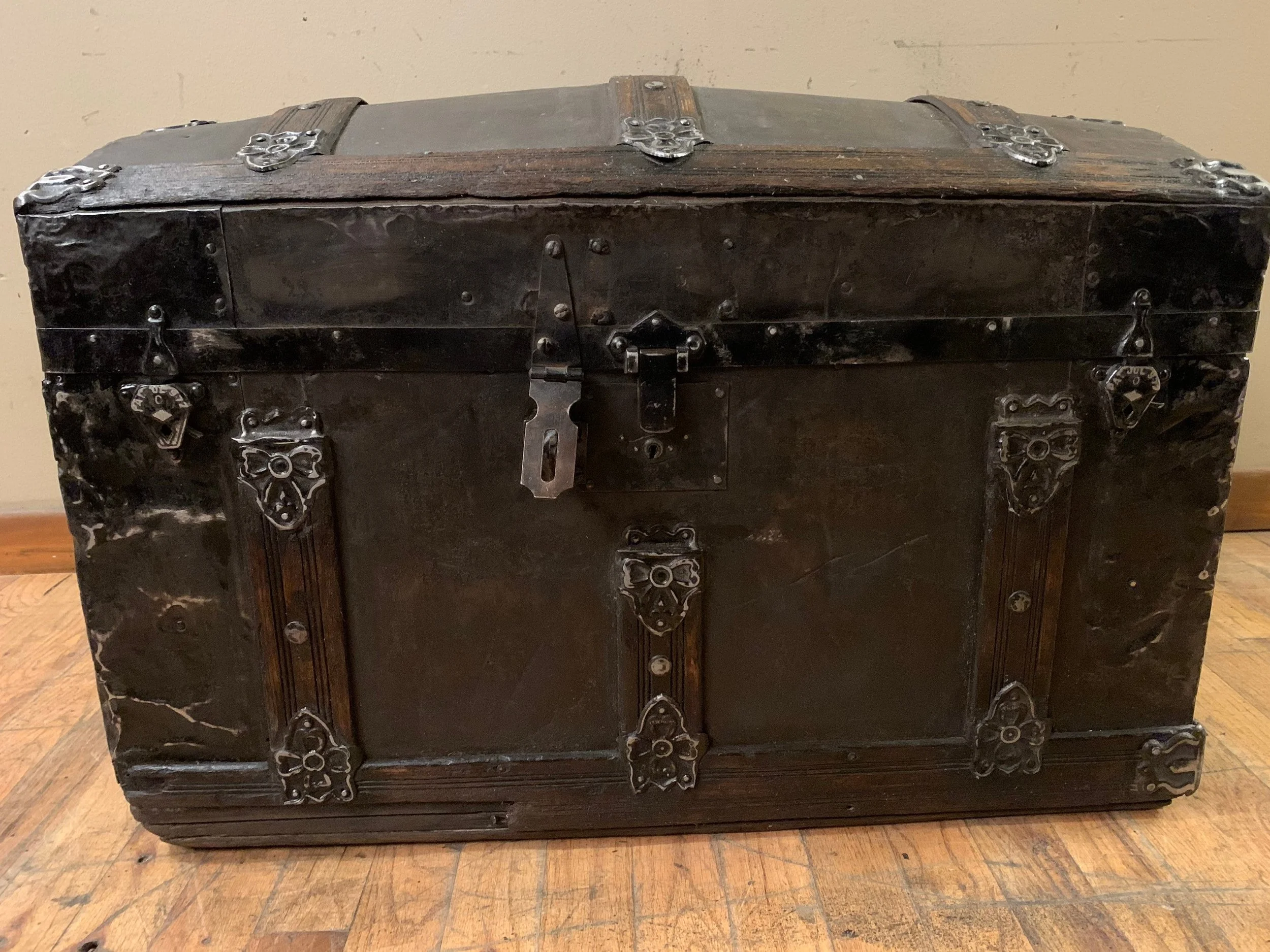 Small antique humpback steamer trunk with refinished brown and black finish