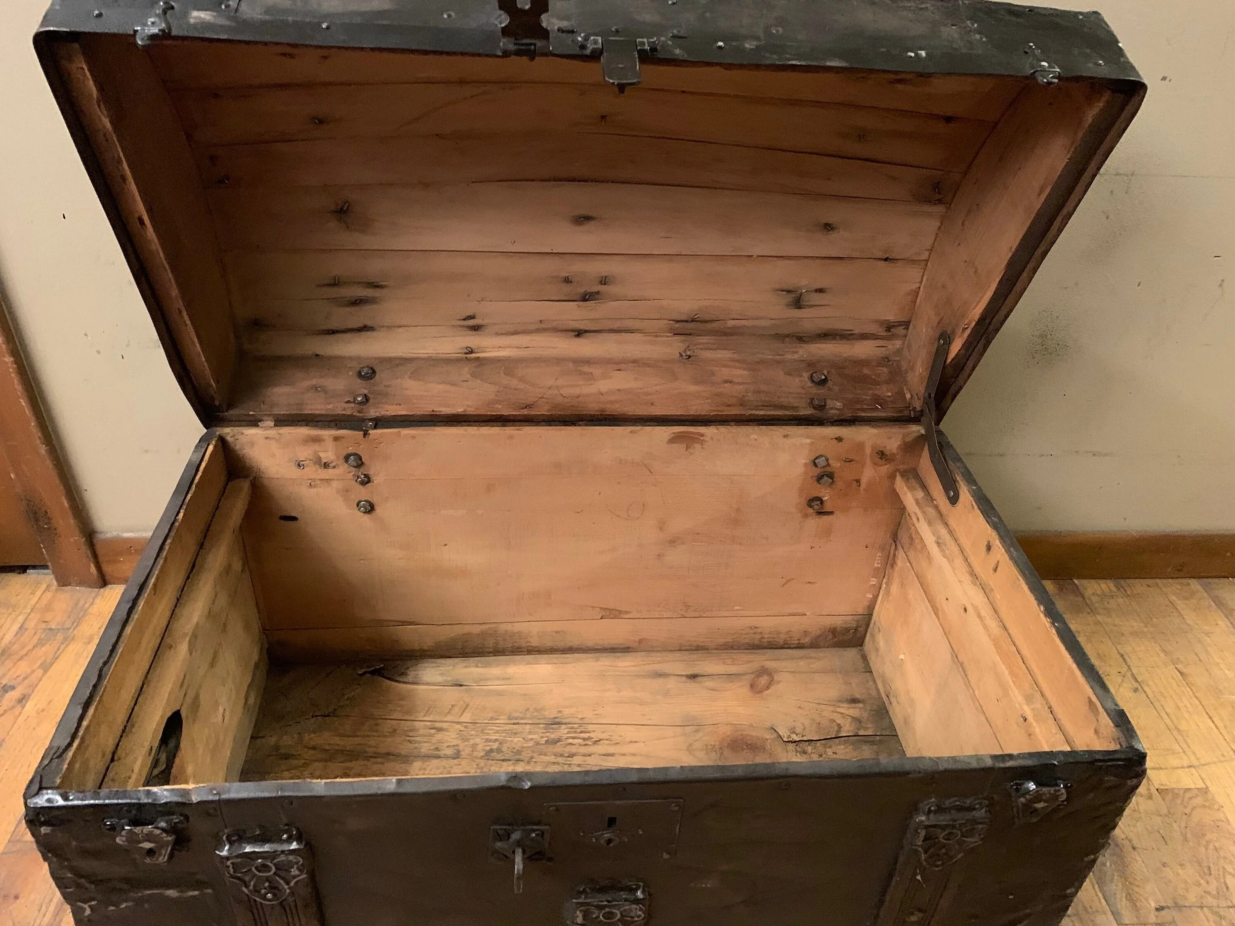 Restored interior of antique humpback storage trunk