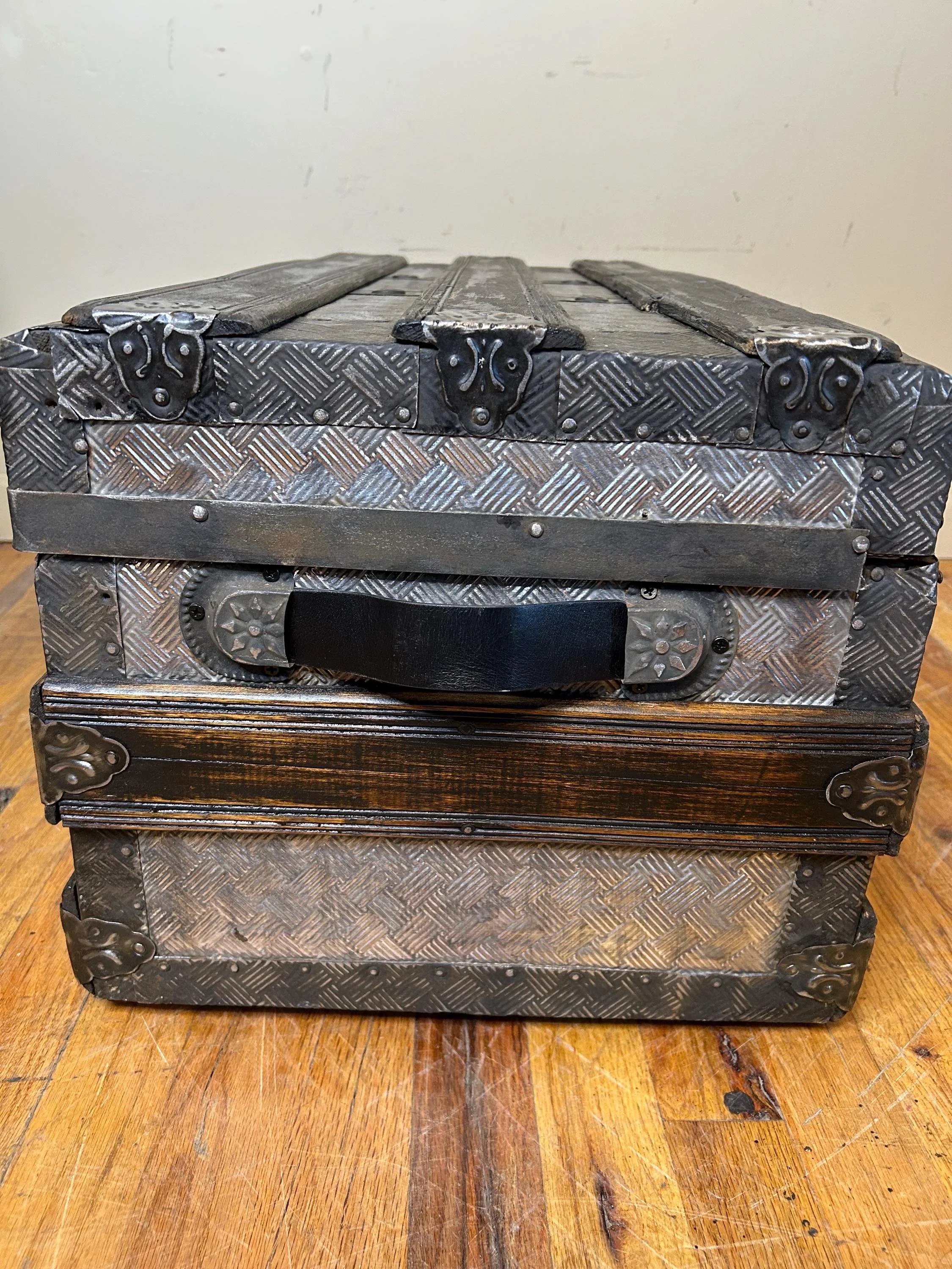Antique embossed tin trunk with dark walnut slats and black accents
