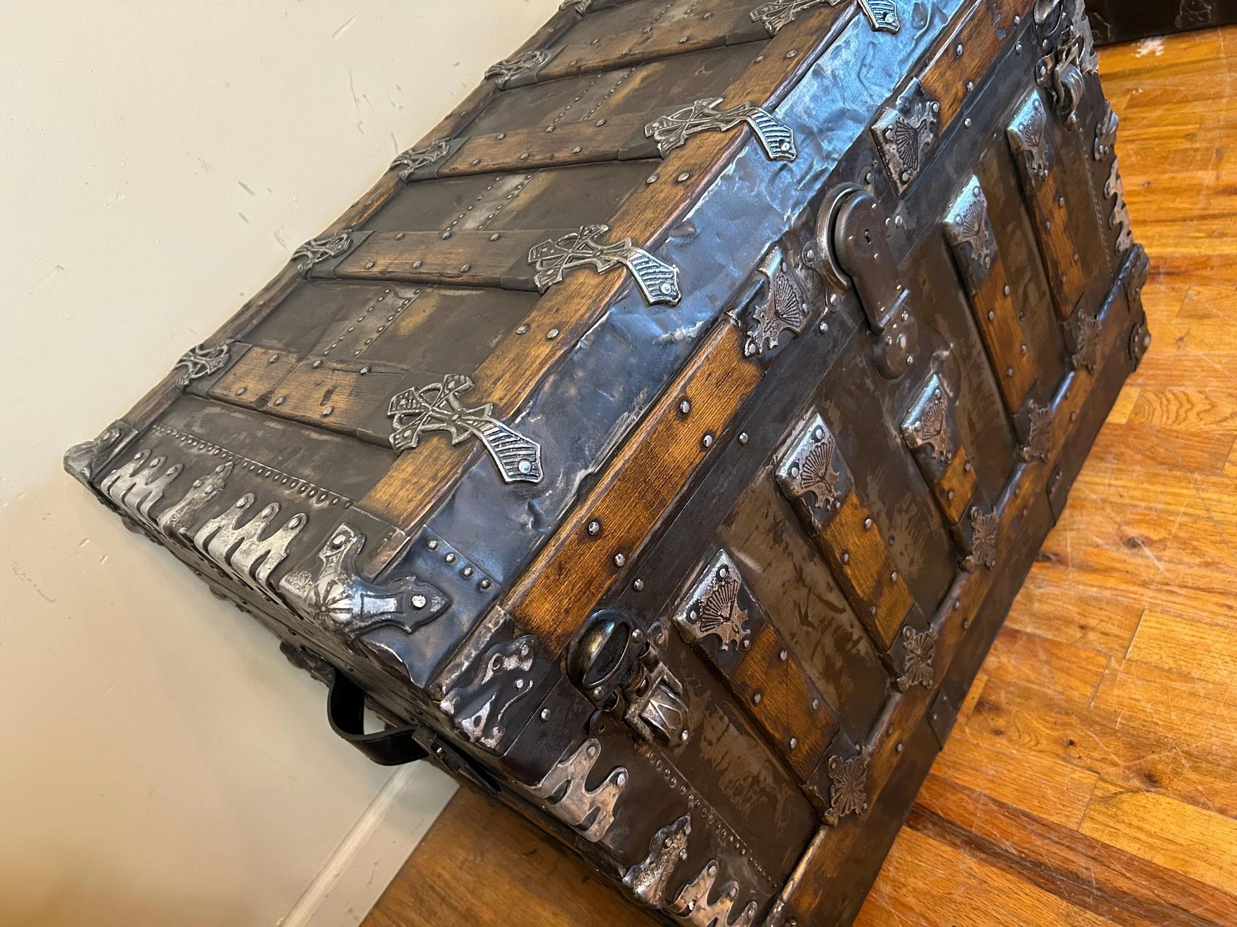 Large flat top travel chest used as a moody industrial coffee table in a modern home