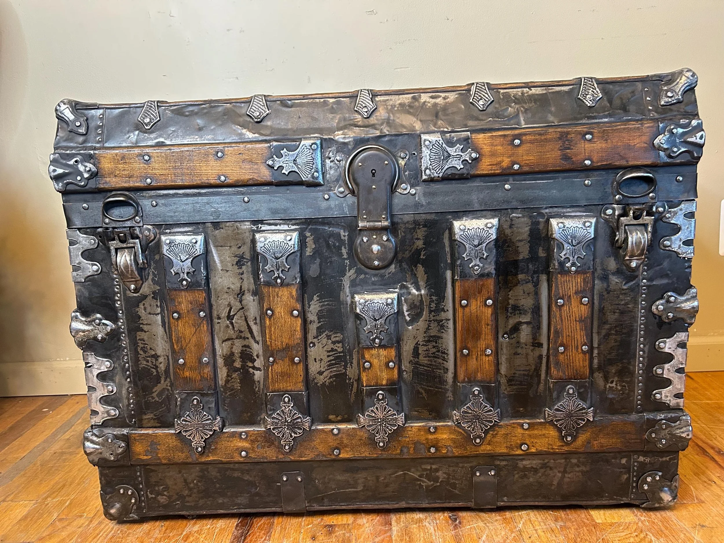 Industrial style storage coffee table with a level top and architectural hardware.