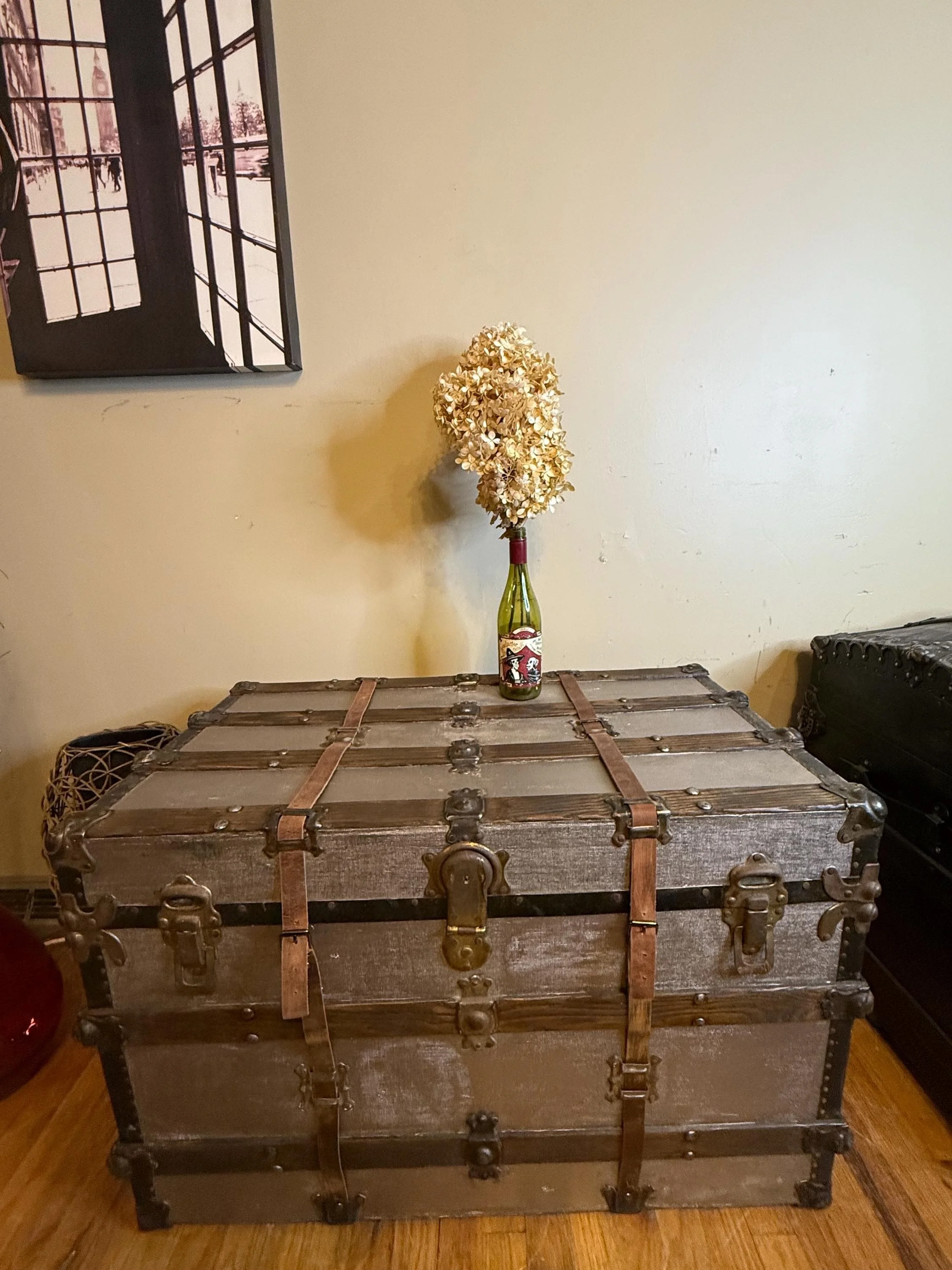 Industrial style storage coffee table with a level silver-painted canvas surface.