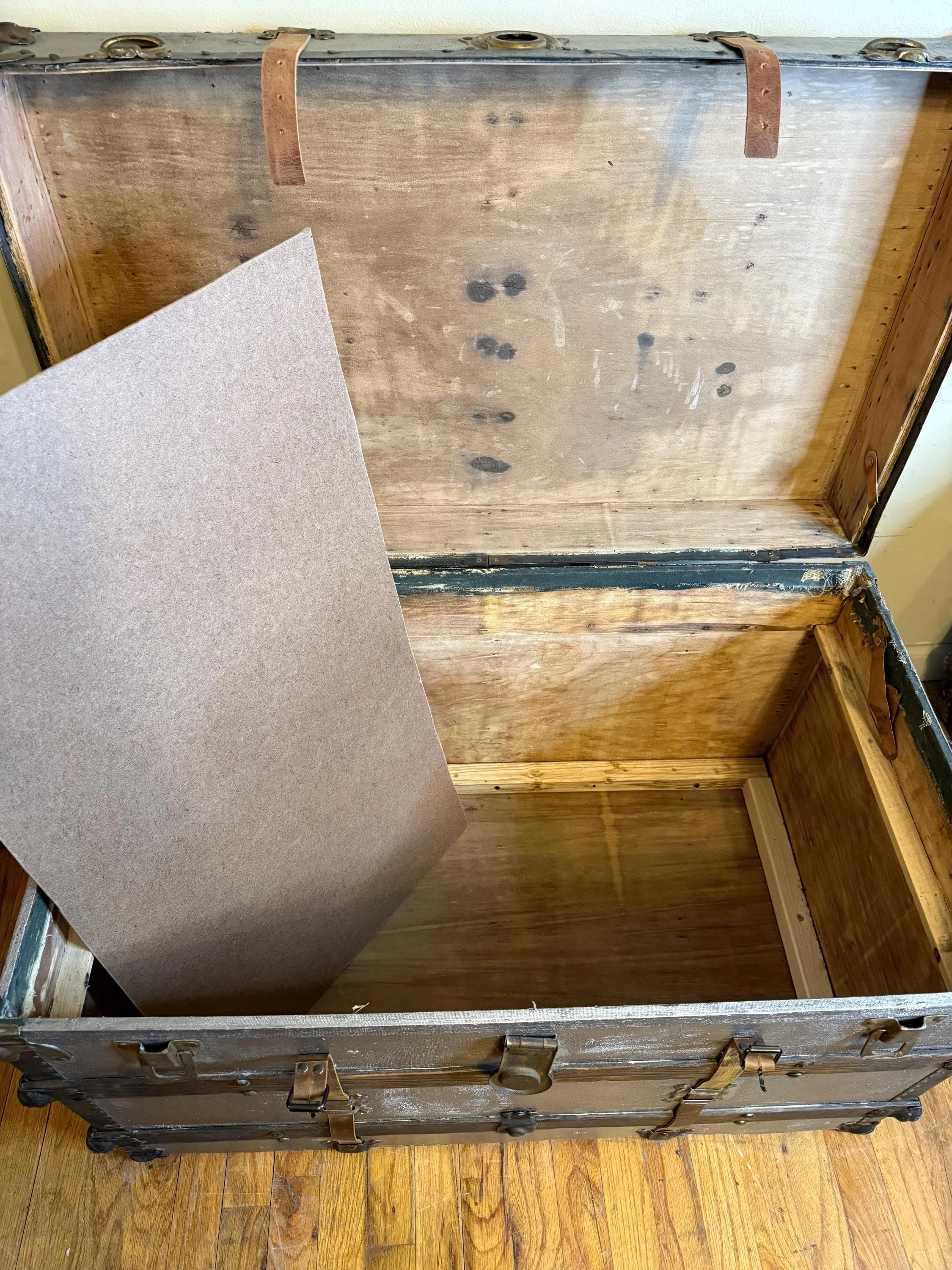 Close-up of the hidden storage area and custom false bottom construction.