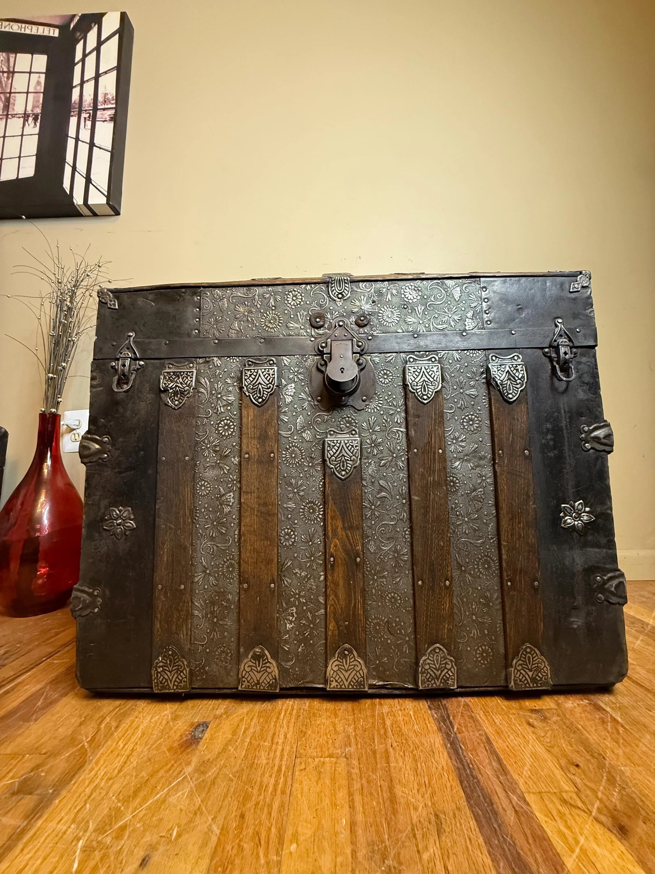 Masterfully restored antique dome top trunk with a rare floral embossed tin pattern.