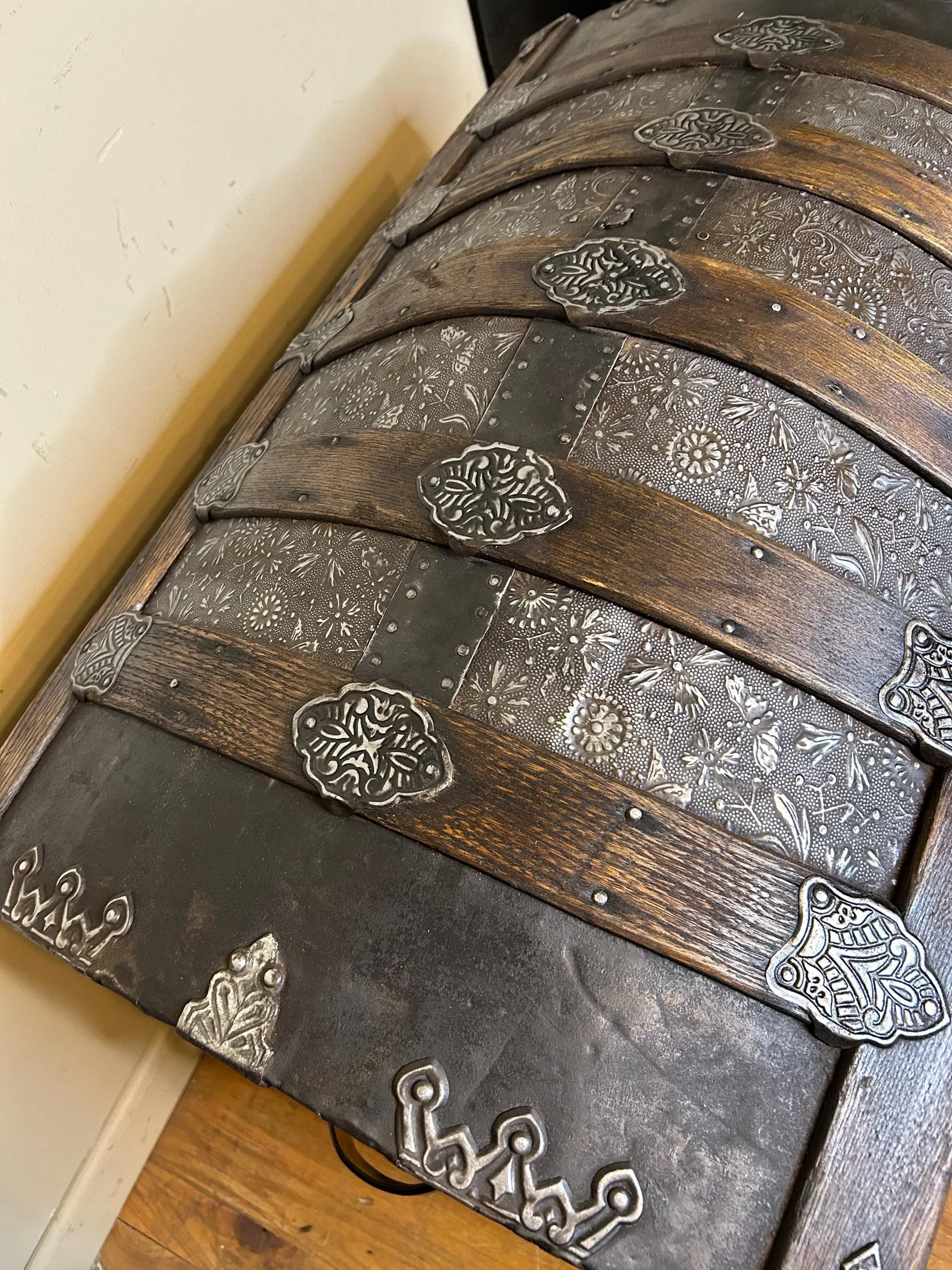 Large rare floral Saratoga trunk providing deep storage for heirlooms.